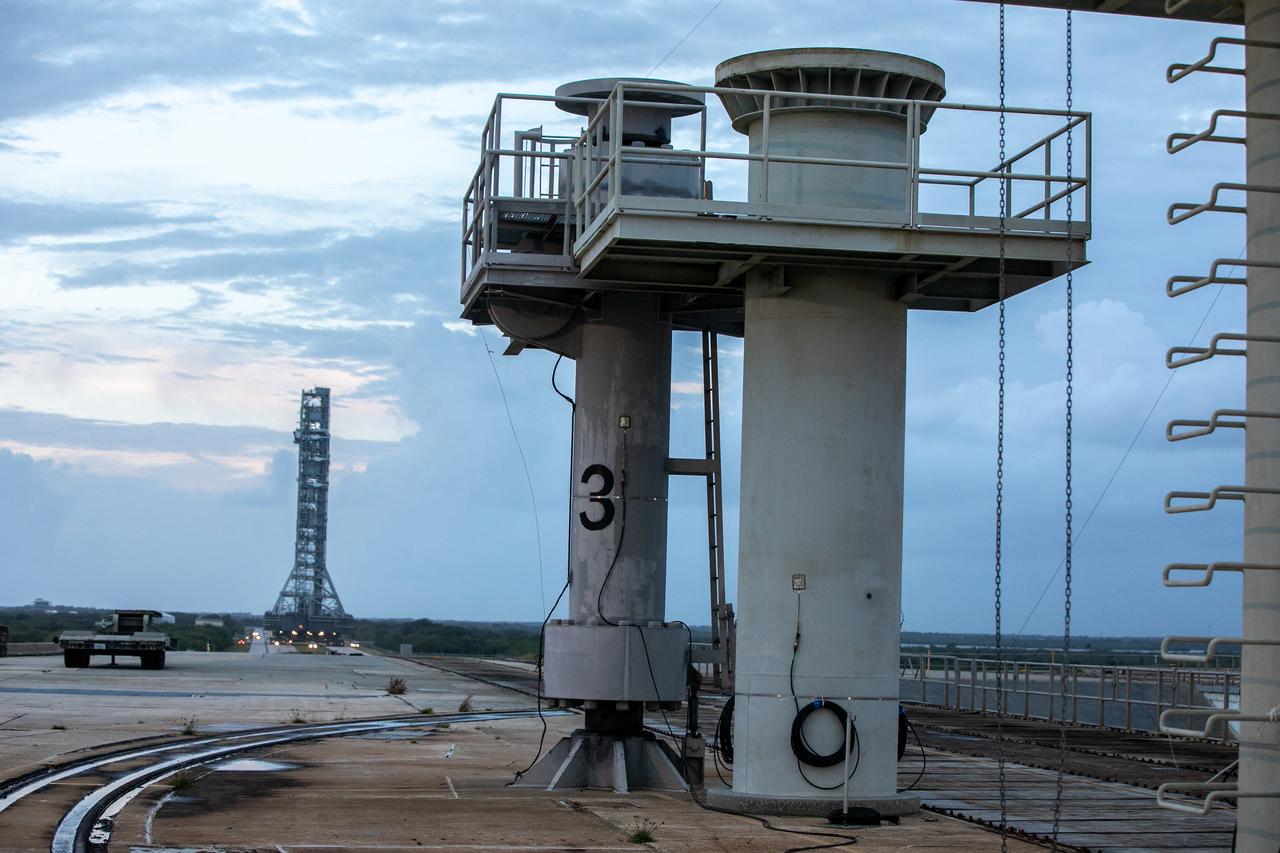 During sunrise on Oct. 20, 2020, the mobile launcher for the Artemis I mission, atop crawler-transporter 2, nears the top of Launch Pad 39B at NASA’s Kennedy Space Center in Florida. The nearly 400-foot-tall mobile launcher will remain at the pad, while engineers with Exploration Ground Systems and Jacobs will perform several tasks, including a timing test to validate the launch team’s countdown timeline, and a thorough, top-to-bottom wash down of the mobile launcher to remove any debris remaining from construction and installation of the umbilical arms. Artemis I will test the Orion spacecraft and Space Launch System as an integrated system ahead of crewed flights to the Moon. Under the Artemis program, NASA will land the first woman and the next man on the Moon in 2024.