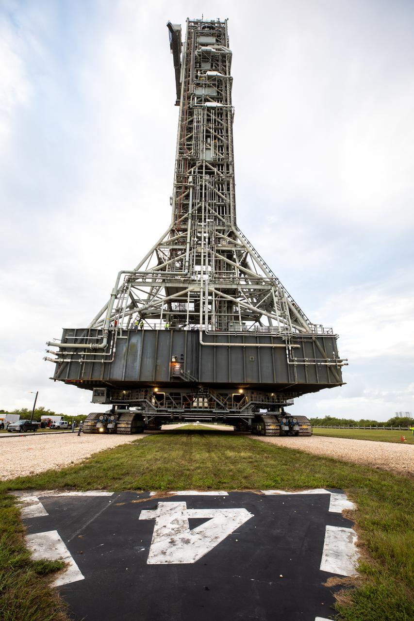 During sunrise on Oct. 20, 2020, the mobile launcher for the Artemis I mission, atop crawler-transporter 2, nears the top of Launch Pad 39B at NASA’s Kennedy Space Center in Florida. The nearly 400-foot-tall mobile launcher will remain at the pad for two weeks, while engineers with Exploration Ground Systems and Jacobs will perform several tasks, including a timing test to validate the launch team’s countdown timeline, and a thorough, top-to-bottom wash down of the mobile launcher to remove any debris remaining from construction and installation of the umbilical arms. Artemis I will test the Orion spacecraft and Space Launch System as an integrated system ahead of crewed flights to the Moon. Under the Artemis program, NASA will land the first woman and the next man on the Moon in 2024.