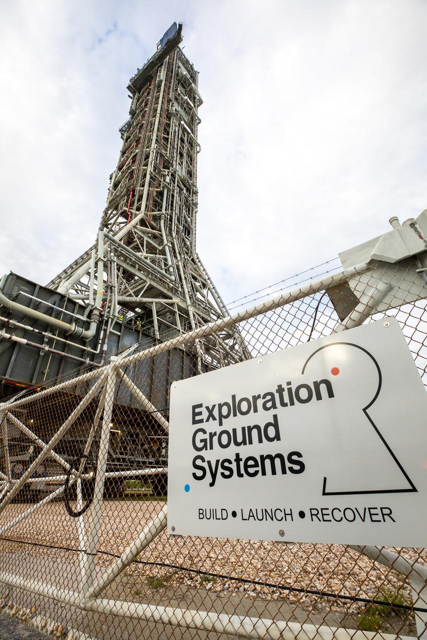 During sunrise on Oct. 20, 2020, the mobile launcher for the Artemis I mission, atop crawler-transporter 2, arrives at the perimeter of Launch Pad 39B at NASA’s Kennedy Space Center in Florida. The nearly 400-foot-tall mobile launcher will remain at the pad for two weeks, while engineers with Exploration Ground Systems and Jacobs will perform several tasks, including a timing test to validate the launch team’s countdown timeline, and a thorough, top-to-bottom wash down of the mobile launcher to remove any debris remaining from construction and installation of the umbilical arms. Artemis I will test the Orion spacecraft and Space Launch System as an integrated system ahead of crewed flights to the Moon. Under the Artemis program, NASA will land the first woman and the next man on the Moon in 2024.