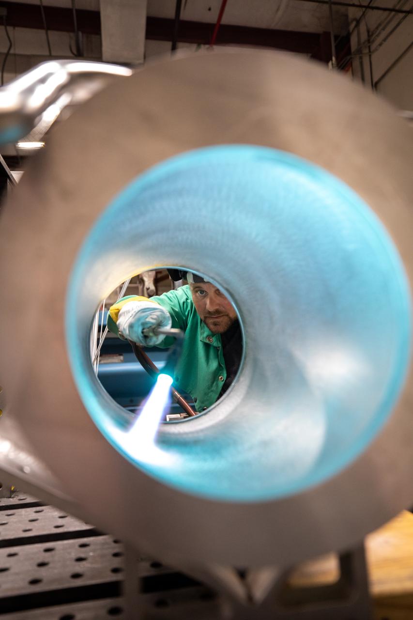 Spencer Wells, a mechanical engineering technician, examines the interior of a camera enclosure for Launch Complex 39B inside the Prototype Development Laboratory at NASA’s Kennedy Space Center in Florida on Oct. 21, 2020. The prototype laboratory designs, fabricates, and tests prototypes, test articles and test support equipment. It has a long history of providing fast solutions to complex operations problems. The lab’s teams of engineers use specialized equipment to produce exacting, one-of-a-kind items made from a range of materials depending on the design. The lab supports projects at Kennedy and at the agency level.