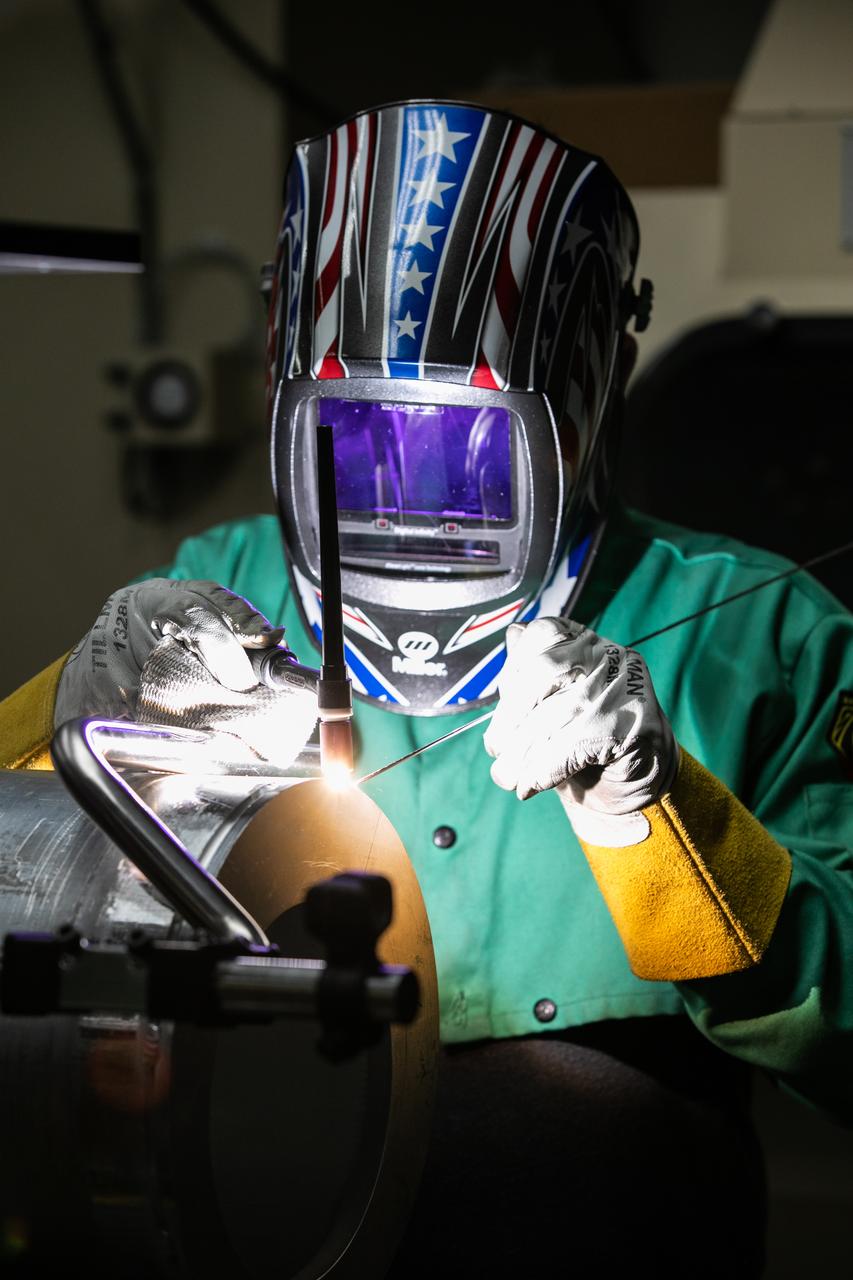 Spencer Wells, a mechanical engineering technician, welds a part of a camera enclosure which will be used at Launch Complex 39B inside the Prototype Development Laboratory at NASA’s Kennedy Space Center in Florida on Oct. 21, 2020. The prototype laboratory designs, fabricates, and tests prototypes, test articles and test support equipment. It has a long history of providing fast solutions to complex operations problems. The lab’s teams of engineers use specialized equipment to produce exacting, one-of-a-kind items made from a range of materials depending on the design. The lab supports projects at Kennedy and at the agency level.