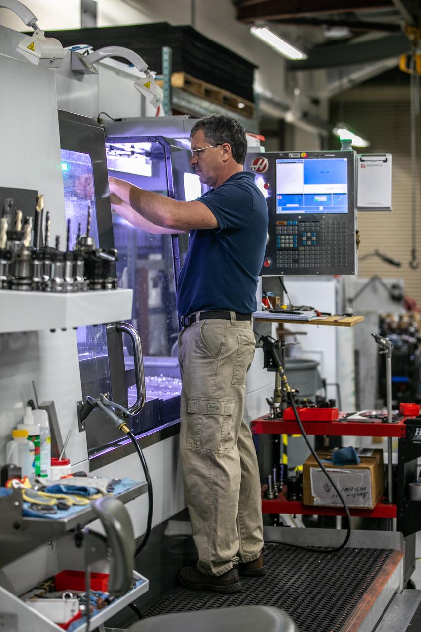 Tim Evans, a mechanical engineering technician, uses a computer numerical control (CNC) machine to machine a part for a Launch Pad 39B camera enclosure inside the Prototype Development Laboratory at NASA’s Kennedy Space Center in Florida on Oct. 21, 2020. The prototype laboratory designs, fabricates, and tests prototypes, test articles and test support equipment. It has a long history of providing fast solutions to complex operations problems. The lab’s teams of engineers use specialized equipment to produce exacting, one-of-a-kind items made from a range of materials depending on the design. The lab supports projects at Kennedy and at the agency level.