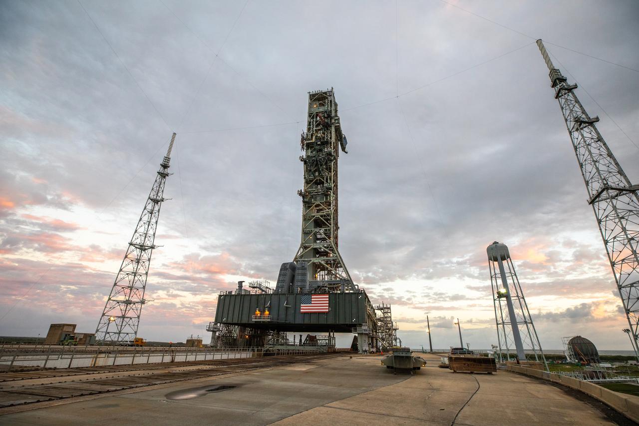 The mobile launcher for the Artemis I mission is in view on the top of Launch Pad 39B at NASA’s Kennedy Space Center in Florida on Oct. 23, 2020. The nearly 400-foot-tall mobile launcher is at the pad to allow engineers with Exploration Ground Systems and Jacobs to complete several tasks, including a timing test to validate the launch team’s countdown timeline, and a thorough, top-to-bottom wash down of the mobile launcher to remove any debris remaining from construction and installation of the umbilical arms. Artemis I will test the Orion spacecraft and Space Launch System as an integrated system ahead of crewed flights to the Moon. Under the Artemis program, NASA will land the first woman and the next man on the Moon in 2024.