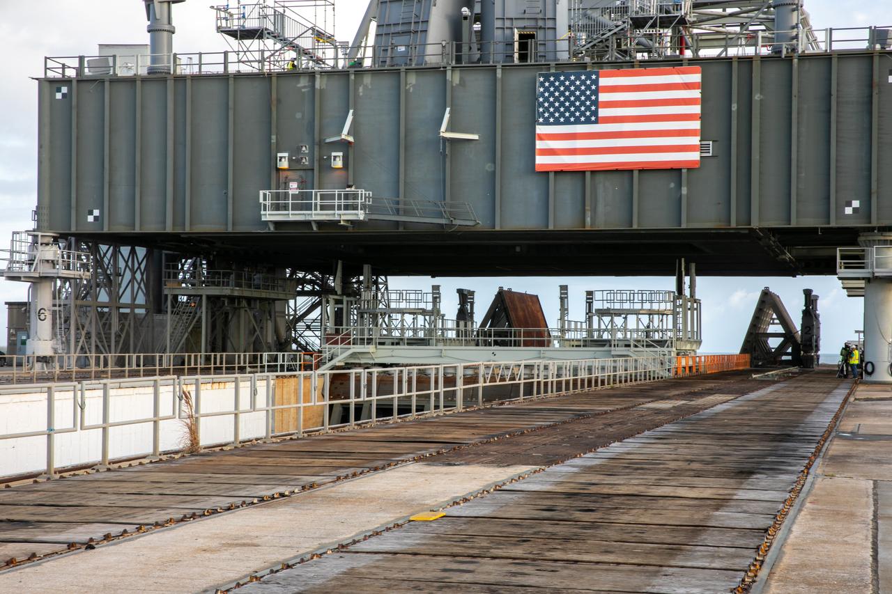 The base of the mobile launcher for Artemis I is in view on Launch Pad 3B at NASA’s Kennedy Space Center in Florida on Oct. 23, 2020. Workers on scaffolding are preparing for a launch countdown demonstration. The nearly 400-foot-tall mobile launcher will remain at the pad while engineers with Exploration Ground Systems and Jacobs complete several tasks, including a timing test to validate the launch team’s countdown timeline, and a thorough, top-to-bottom wash down of the mobile launcher to remove any debris remaining from construction and installation of the umbilical arms. Artemis I will test the Orion spacecraft and Space Launch System as an integrated system ahead of crewed flights to the Moon. Under the Artemis program, NASA will land the first woman and the next man on the Moon in 2024.