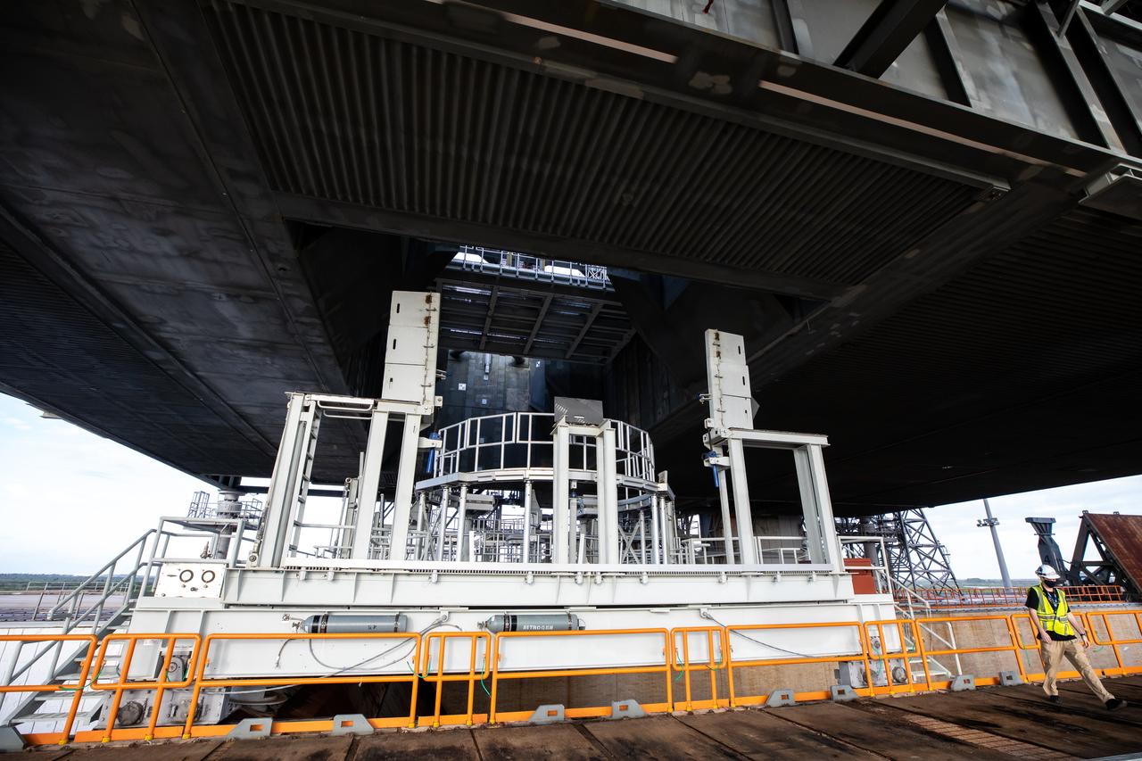 The engine service platform is moved into position beneath the mobile launcher for Artemis I at Launch Pad 39B on Oct. 23, 2020, at NASA’s Kennedy Space Center in Florida. The service platform allows access to the RS-25 engines on the Space Launch System core stage for routine work or inspections. The nearly 400-foot-tall mobile launcher will remain at the pad while engineers with Exploration Ground Systems and Jacobs complete several tasks, including a timing test to validate the launch team’s countdown timeline, and a thorough, top-to-bottom wash down of the mobile launcher to remove any debris remaining from construction and installation of the umbilical arms. Artemis I will test the Orion spacecraft and Space Launch System as an integrated system ahead of crewed flights to the Moon. Under the Artemis program, NASA will land the first woman and the next man on the Moon in 2024.