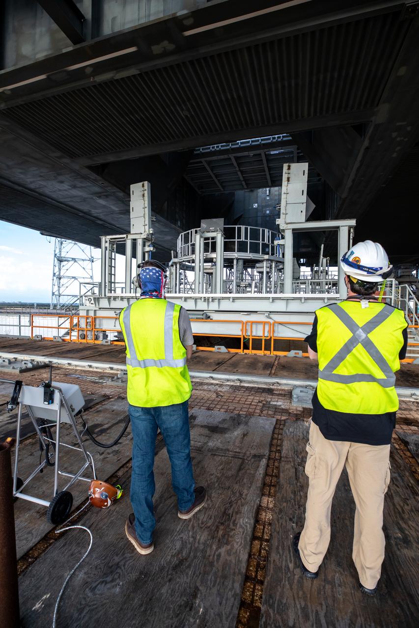 The engine service platform is moved into position beneath the mobile launcher for Artemis I at Launch Pad 39B on Oct. 23, 2020, at NASA’s Kennedy Space Center in Florida. The service platform allows access to the RS-25 engines on the Space Launch System core stage for routine work or inspections. The nearly 400-foot-tall mobile launcher will remain at the pad while engineers with Exploration Ground Systems and Jacobs will complete several tasks, including a timing test to validate the launch team’s countdown timeline, and a thorough, top-to-bottom wash down of the mobile launcher to remove any debris remaining from construction and installation of the umbilical arms. Artemis I will test the Orion spacecraft and Space Launch System as an integrated system ahead of crewed flights to the Moon. Under the Artemis program, NASA will land the first woman and the next man on the Moon in 2024.