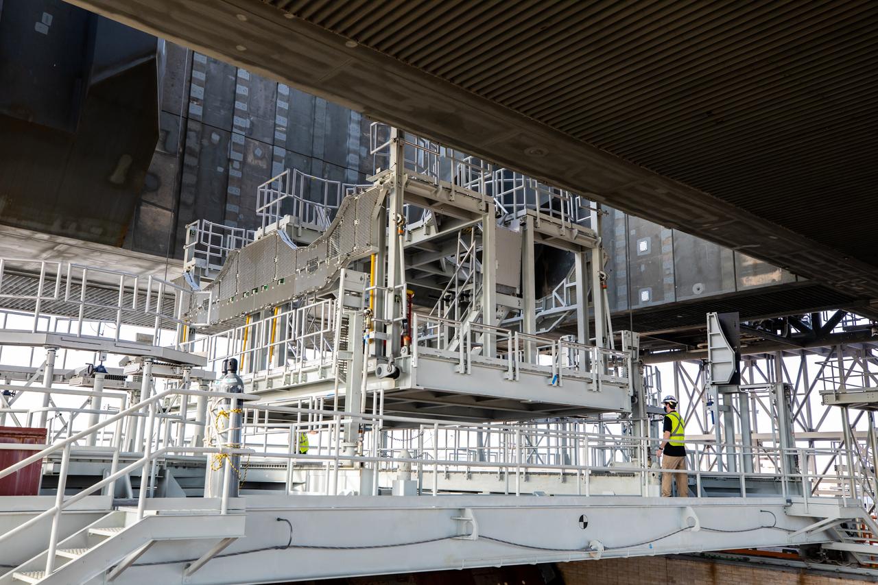 The engine service platform is being raised beneath the mobile launcher for Artemis I at Launch Pad 39B at NASA’s Kennedy Space Center in Florida on Oct. 23, 2020. The nearly 400-foot-tall mobile launcher is at the pad while engineers with Exploration Ground Systems and Jacobs complete several tasks, including a timing test to validate the launch team’s countdown timeline, and a thorough, top-to-bottom wash down of the mobile launcher to remove any debris remaining from construction and installation of the umbilical arms. Artemis I will test the Orion spacecraft and Space Launch System as an integrated system ahead of crewed flights to the Moon. Under the Artemis program, NASA will land the first woman and the next man on the Moon in 2024.