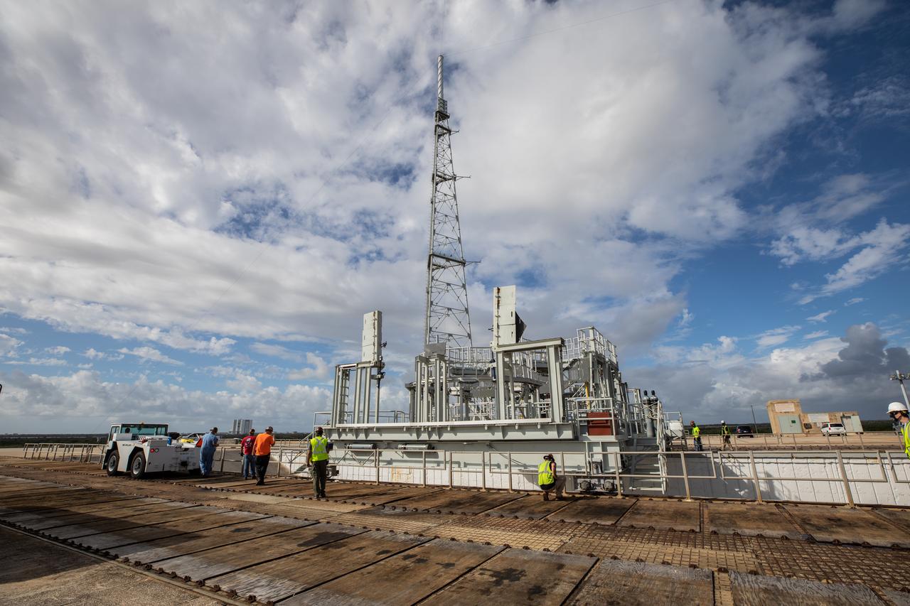 A view of Launch Complex 39B at NASA’s Kennedy Space Center in Florida on Oct. 23, 2020. The mobile launcher for Artemis I is at the pad. The nearly 400-foot-tall mobile launcher is at the pad while engineers with Exploration Ground Systems and Jacobs complete several tasks, including a timing test to validate the launch team’s countdown timeline, and a thorough, top-to-bottom wash down of the mobile launcher to remove any debris remaining from construction and installation of the umbilical arms. Artemis I will test the Orion spacecraft and Space Launch System as an integrated system ahead of crewed flights to the Moon. Under the Artemis program, NASA will land the first woman and the next man on the Moon in 2024.