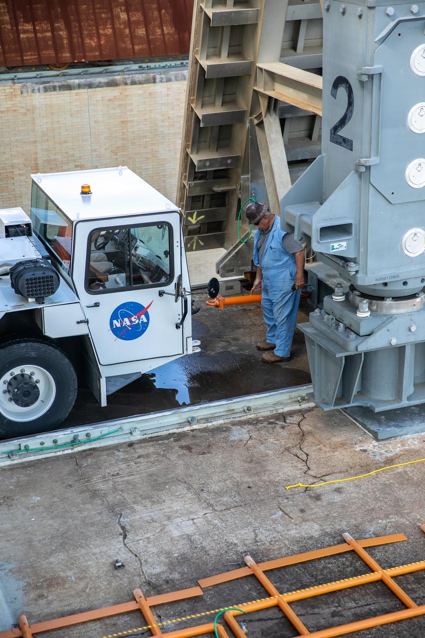 Special ground support equipment is used to move the side flame deflectors into place during a countdown demonstration test using the mobile launcher for the Artemis I mission at Launch Pad 39B at NASA’s Kennedy Space Center in Florida on Oct. 23, 2020. The nearly 400-foot-tall mobile launcher is at the pad while engineers with Exploration Ground Systems and Jacobs complete several tasks, including a timing test to validate the launch team’s countdown timeline, and a thorough, top-to-bottom wash down of the mobile launcher to remove any debris remaining from construction and installation of the umbilical arms. Artemis I will test the Orion spacecraft and Space Launch System as an integrated system ahead of crewed flights to the Moon. Under the Artemis program, NASA will land the first woman and the next man on the Moon in 2024.