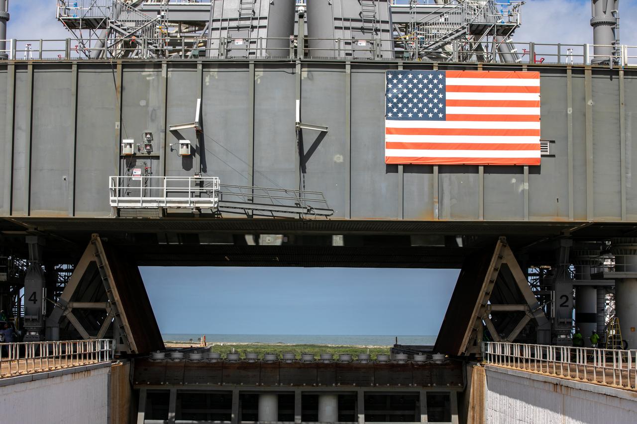 A close-up view of the base of the mobile launcher for Artemis I with the two side flame deflectors positioned underneath during a countdown demonstration test at Launch Pad 39B at NASA’s Kennedy Space Center in Florida on Oct. 23, 2020. The nearly 400-foot-tall mobile launcher is at the pad while engineers with Exploration Ground Systems and Jacobs complete several tasks, including a timing test to validate the launch team’s countdown timeline, and a thorough, top-to-bottom wash down of the mobile launcher to remove any debris remaining from construction and installation of the umbilical arms. Artemis I will test the Orion spacecraft and Space Launch System as an integrated system ahead of crewed flights to the Moon. Under the Artemis program, NASA will land the first woman and the next man on the Moon in 2024.