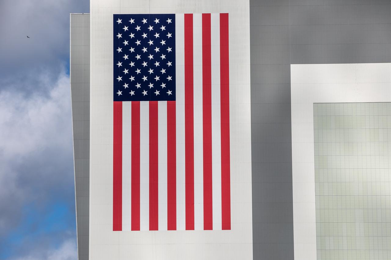 A freshly painted American Flag on the Vehicle Assembly Building (VAB) at NASA’s Kennedy Space Center in Florida is photographed on Oct. 27, 2020. HM2 and H.I.S. Painting of Titusville, Florida, began repainting the NASA logo, referred to as the meatball, and flag on the iconic facility in May. The flag measures 209 feet long by 110 feet wide; each star is more than six feet in diameter, and each stripe is nine feet wide. It took over 500 gallons of paint to repaint the flag and the 110’ X 132’ meatball.