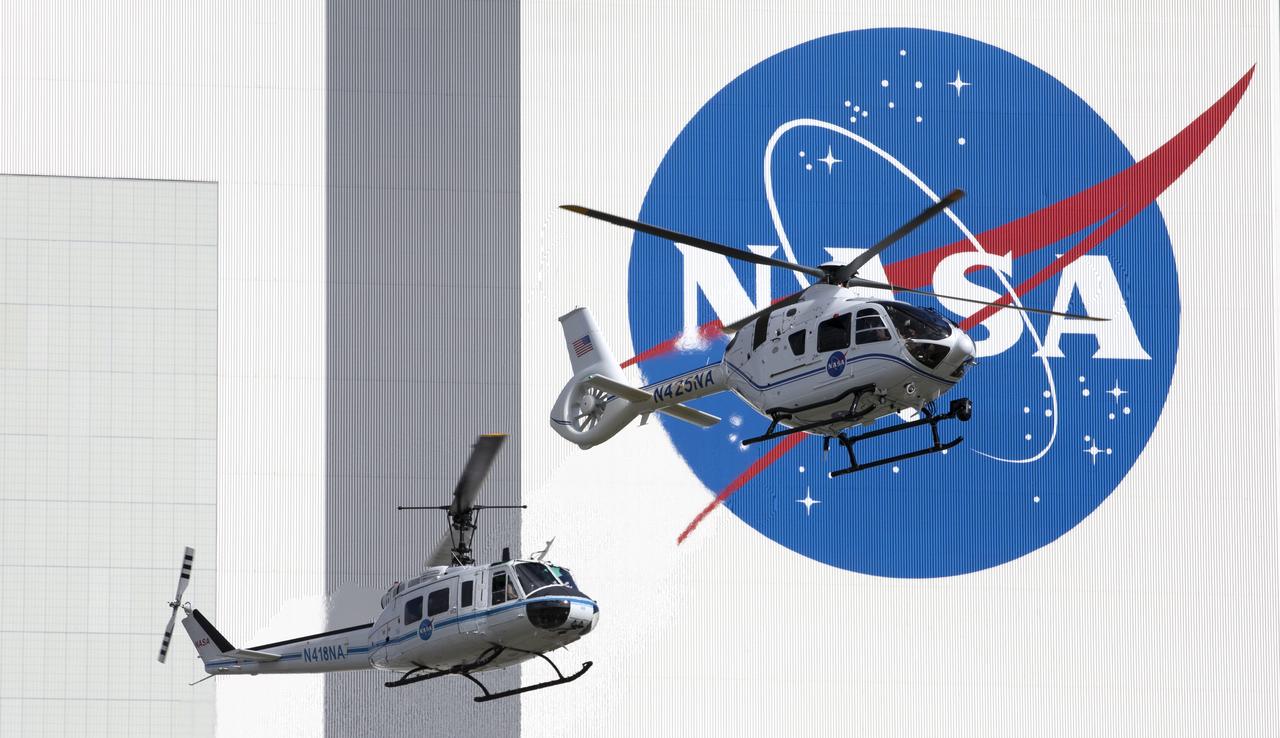 On Oct. 27, 2020, in front of the iconic Vehicle Assembly Building at NASA’s Kennedy Space Center, the Bell Huey 2 (left) and Airbus H135 helicopters used for security operations at the Florida spaceport perform one flight together before the Hueys are retired from their service. The Airbus H135s are replacing the three Bell Huey 2 aircraft maintained by Kennedy’s Flight Operations team. Kennedy received two of the H135 aircraft on Sept. 30, and the third is expected to arrive in spring 2021. These new helicopters provide a number of technological and safety advantages over the Hueys, such as more lifting power, greater stability in the air, and expanded medical capabilities.