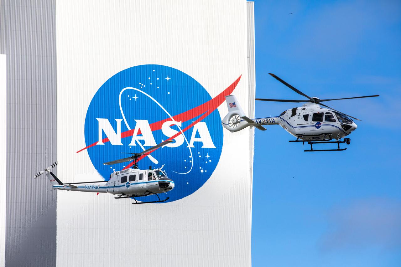 On Oct. 27, 2020, in front of the iconic Vehicle Assembly Building at NASA’s Kennedy Space Center, the Bell Huey 2 (left) and Airbus H135 helicopters used for security operations at the Florida spaceport perform one flight together before the Hueys are retired from their service. The Airbus H135s are replacing the three Bell Huey 2 aircraft maintained by Kennedy’s Flight Operations team. Kennedy received two of the H135 aircraft on Sept. 30, and the third is expected to arrive in spring 2021. These new helicopters provide a number of technological and safety advantages over the Hueys, such as more lifting power, greater stability in the air, and expanded medical capabilities.
