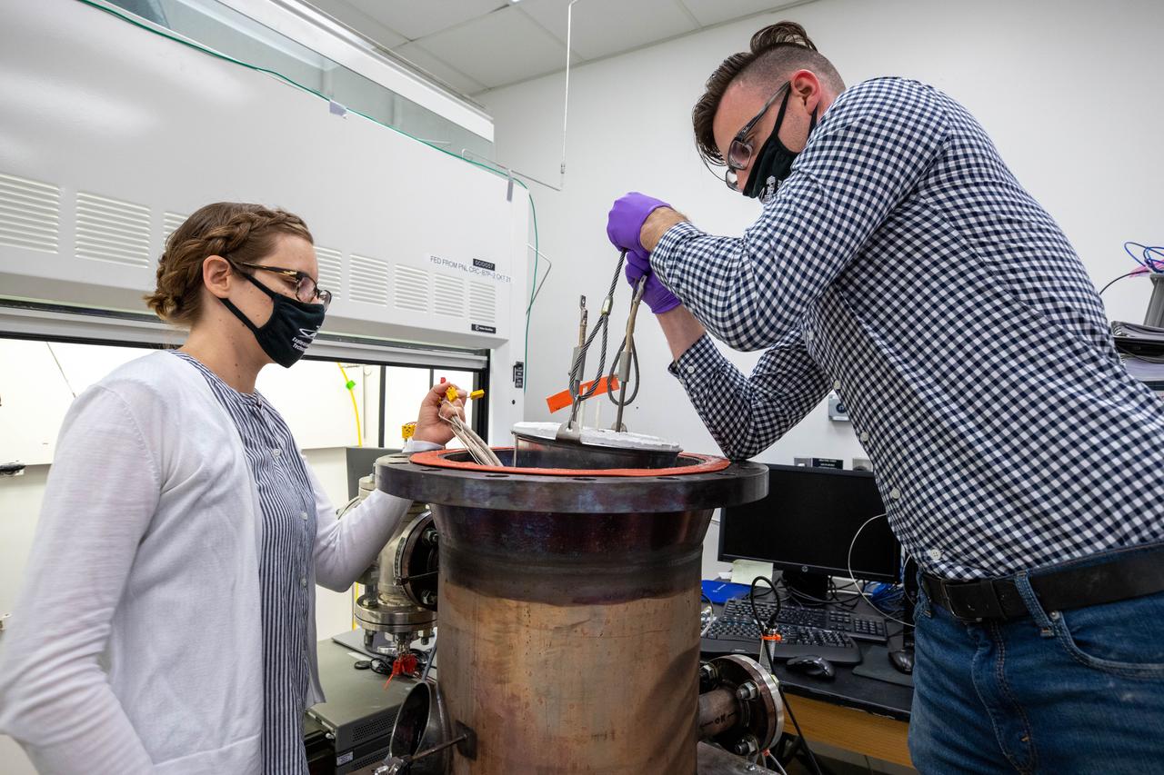 Elspeth Petersen, left, a chemical engineer and member of the Gaseous Lunar Oxygen from Regolith Electrolysis (GaLORE) project team, and Kevin Grossman, GaLORE principal investigator, inspect a reactor before a test to melt lunar regolith – dirt and dust on the Moon made from crushed rock – simulants inside a laboratory at Kennedy’s Neil Armstrong Operations and Checkout Building on Oct. 29, 2020. GaLORE was selected as an Early Career Initiative project by the agency’s Space Technology Mission directorate, and the team was tasked with developing a device that could melt lunar regolith and turn it into oxygen. As NASA prepares to land the first woman and the next man on the Moon in 2024 as part of the Artemis program, technology such as this can assist with sustainable human lunar exploration and long-duration missions to Mars. 