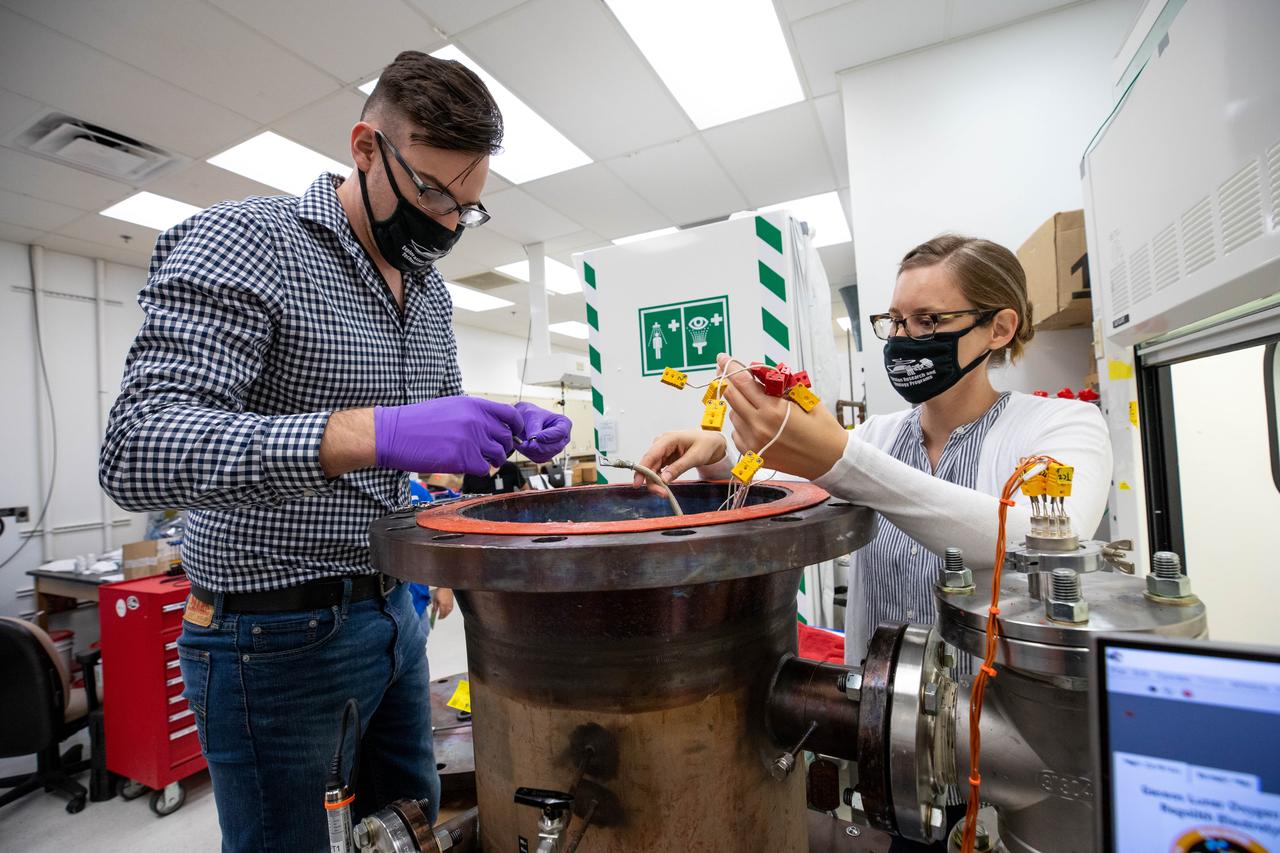 Kevin Grossman, left, principal investigator of the Gaseous Lunar Oxygen from Regolith Electrolysis (GaLORE) project, and Elspeth Petersen, a chemical engineer and member of the GaLORE team, check some of the project’s hardware that will be used to melt lunar regolith – dirt and dust on the Moon made from crushed rock – simulants during a test inside a laboratory at Kennedy’s Neil Armstrong Operations and Checkout Building on Oct. 29, 2020. GaLORE was selected as an Early Career Initiative project by the agency’s Space Technology Mission directorate, and the team was tasked with developing a device that could melt lunar regolith and turn it into oxygen. As NASA prepares to land the first woman and the next man on the Moon in 2024 as part of the Artemis program, technology such as this can assist with sustainable human lunar exploration and long-duration missions to Mars. 