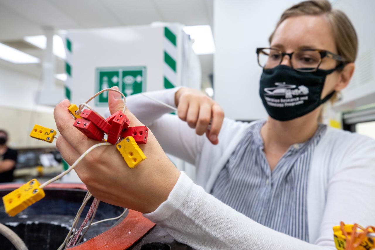 Elspeth Petersen, a chemical engineer and member of the Gaseous Lunar Oxygen from Regolith Electrolysis (GaLORE) project team at NASA’s Kennedy Space Center in Florida, inspects some of the GaLORE hardware that will be used to melt lunar regolith – dirt and dust on the Moon made from crushed rock – simulants during a test inside a laboratory at Kennedy’s Neil Armstrong Operations and Checkout Building on Oct. 29, 2020. GaLORE was selected as an Early Career Initiative project by the agency’s Space Technology Mission directorate, and the team was tasked with developing a device that could melt lunar regolith and turn it into oxygen. As NASA prepares to land the first woman and the next man on the Moon in 2024 as part of the Artemis program, technology such as this can assist with sustainable human lunar exploration and long-duration missions to Mars. 