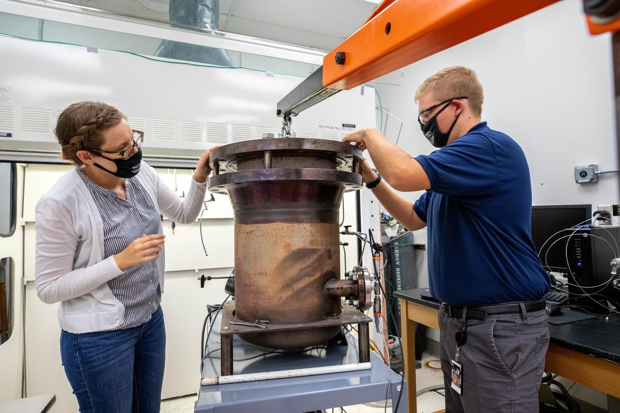 Elspeth Petersen, left, a chemical engineer and member of the Gaseous Lunar Oxygen from Regolith Electrolysis (GaLORE) project team at NASA’s Kennedy Space Center in Florida, and Evan Bell, GaLORE mechanical engineer, inspect hardware that will be used to melt lunar regolith – dirt and dust on the Moon made from crushed rock – stimulants during a test inside a laboratory at Kennedy’s Neil Armstrong Operations and Checkout Building on Oct. 29, 2020. GaLORE was selected as an Early Career Initiative project by the agency’s Space Technology Mission directorate, and the team was tasked with developing a device that could melt lunar regolith and turn it into oxygen. As NASA prepares to land the first woman and the next man on the Moon in 2024 as part of the Artemis program, technology such as this can assist with sustainable human lunar exploration and long-duration missions to Mars. 