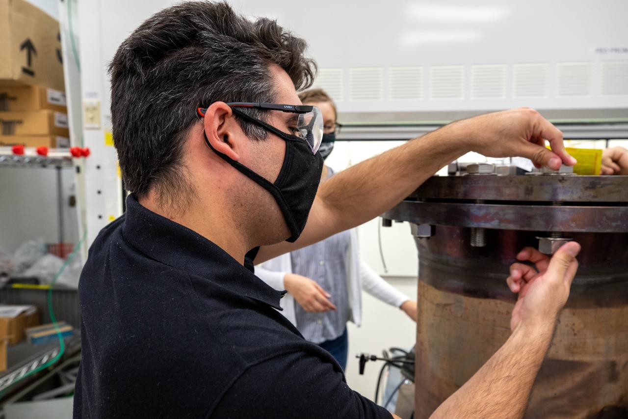 Jaime Toro, a mechanical engineer supporting the Gaseous Lunar Oxygen from Regolith Electrolysis (GaLORE) project at NASA’s Kennedy Space Center in Florida, checks the hardware that will be used to melt lunar regolith – dirt and dust on the Moon made from crushed rock – simulants during a test inside a laboratory at Kennedy’s Neil Armstrong Operations and Checkout Building on Oct. 29, 2020. GaLORE was selected as an Early Career Initiative project by the agency’s Space Technology Mission directorate, and the team was tasked with developing a device that could melt lunar regolith and turn it into oxygen. As NASA prepares to land the first woman and the next man on the Moon in 2024 as part of the Artemis program, technology such as this can assist with sustainable human lunar exploration and long-duration missions to Mars.  