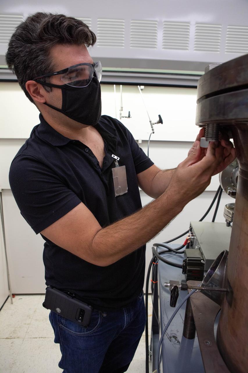 Jaime Toro, a mechanical engineer supporting the Gaseous Lunar Oxygen from Regolith Electrolysis (GaLORE) project at NASA’s Kennedy Space Center in Florida, checks the hardware that will be used to melt lunar regolith – dirt and dust on the Moon made from crushed rock – simulants during a test inside a laboratory at Kennedy’s Neil Armstrong Operations and Checkout Building on Oct. 29, 2020. GaLORE was selected as an Early Career Initiative project by the agency’s Space Technology Mission directorate, and the team was tasked with developing a device that could melt lunar regolith and turn it into oxygen. As NASA prepares to land the first woman and the next man on the Moon in 2024 as part of the Artemis program, technology such as this can assist with sustainable human lunar exploration and long-duration missions to Mars.  