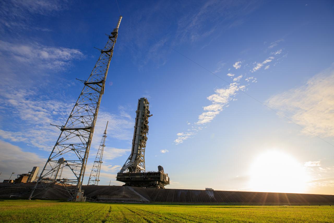 During sunrise on Oct. 30, 2020, the mobile launcher for the Artemis I mission, atop crawler-transporter 2, departs Launch Pad 39B and moves slowly along the crawlerway to return to the Vehicle Assembly Building at NASA’s Kennedy Space Center in Florida. The nearly 400-foot-tall mobile launcher was at the pad for 10 days, while engineers with Exploration Ground Systems and Jacobs performed several tasks, including a timing test to validate the launch team’s countdown timeline, and a thorough, top-to-bottom wash down of the mobile launcher to remove any debris remaining from construction and installation of the umbilical arms. Artemis I will test the Orion spacecraft and Space Launch System as an integrated system ahead of crewed flights to the Moon. Under the Artemis program, NASA will land the first woman and the next man on the Moon in 2024.