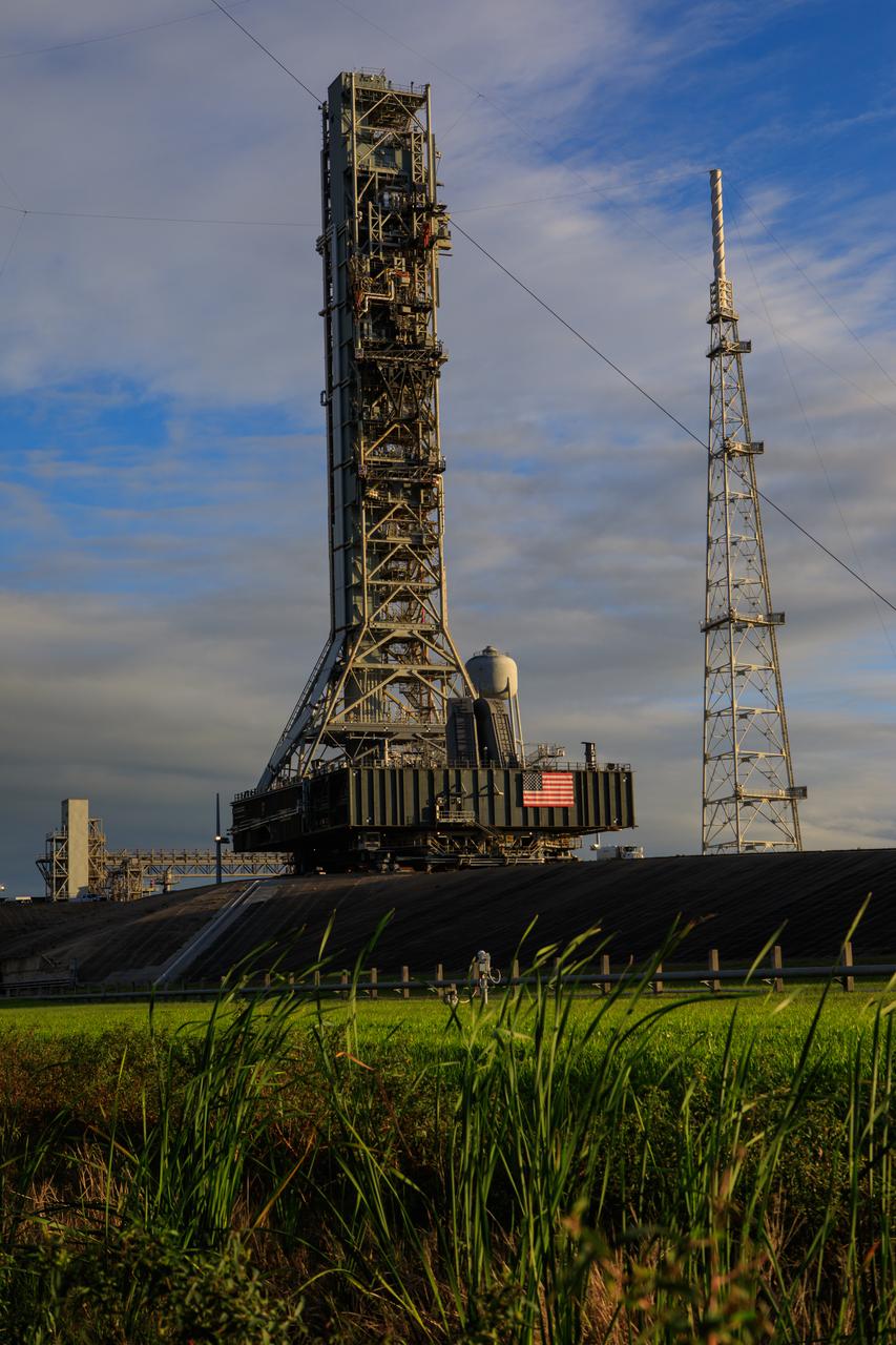 During the morning on Oct. 30, 2020, the mobile launcher for the Artemis I mission, atop crawler-transporter 2, moves slowly along the crawlerway after departing Launch Pad 39B at NASA’s Kennedy Space Center in Florida. The nearly 400-foot-tall mobile launcher is returning to the Vehicle Assembly Building after being at the pad for 10 days, while engineers with Exploration Ground Systems and Jacobs performed several tasks, including a timing test to validate the launch team’s countdown timeline, and a thorough, top-to-bottom wash down of the mobile launcher to remove any debris remaining from construction and installation of the umbilical arms. Artemis I will test the Orion spacecraft and Space Launch System as an integrated system ahead of crewed flights to the Moon. Under the Artemis program, NASA will land the first woman and the next man on the Moon in 2024.