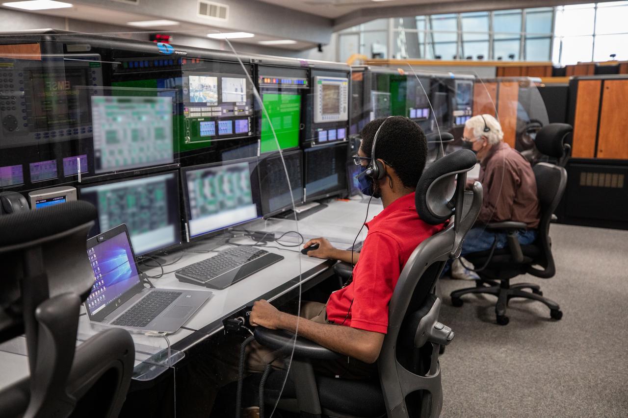 Theo Henderson, left, and Phillip Youmans, members of the cryogenics launch team, participate in a cryogenic propellant loading simulation inside Firing Room 1 in the Launch Control Center on Nov. 2, 2020, at NASA’s Kennedy Space Center in Florida. A team of engineers with Exploration Ground Systems and Jacobs are rehearsing the steps to load the super-cooled liquid hydrogen and liquid oxygen into the Space Launch System’s (SLS) core and second stages to prepare for Artemis I. The first in a series of increasingly complex missions, Artemis I will test the Orion spacecraft and Space Launch System as an integrated system ahead of crewed flights to the Moon. NASA will land the first woman and the next man on the Moon in 2024.