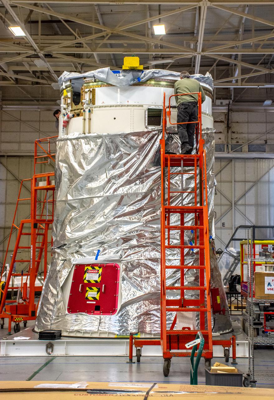 Inside Building 7525, a processing facility at Vandenberg Space Force Base in California, a worker secures the aft stub adapter onto the interstage adapter for the United Launch Alliance Atlas V rocket on Nov. 4, 2020. The Atlas V will launch NASA’s Landsat 9 satellite from Vandenberg in September 2021. The launch is being managed by NASA’s Launch Services Program based at Kennedy Space Center. Landsat 9 will continue the nearly 50-year legacy of previous Landsat missions. It will monitor key natural and economic resources from orbit. Landsat 9 is managed by the agency’s Goddard Space Flight Center in Greenbelt, Maryland. It will carry two instruments: the Operational Land Imager 2, which collects images of Earth’s landscapes in visible, near infrared and shortwave infrared light, and the Thermal Infrared Sensor 2, which measures the temperature of land surfaces. Like its predecessors, Landsat 9 is a joint mission between NASA and the U.S. Geological Survey.