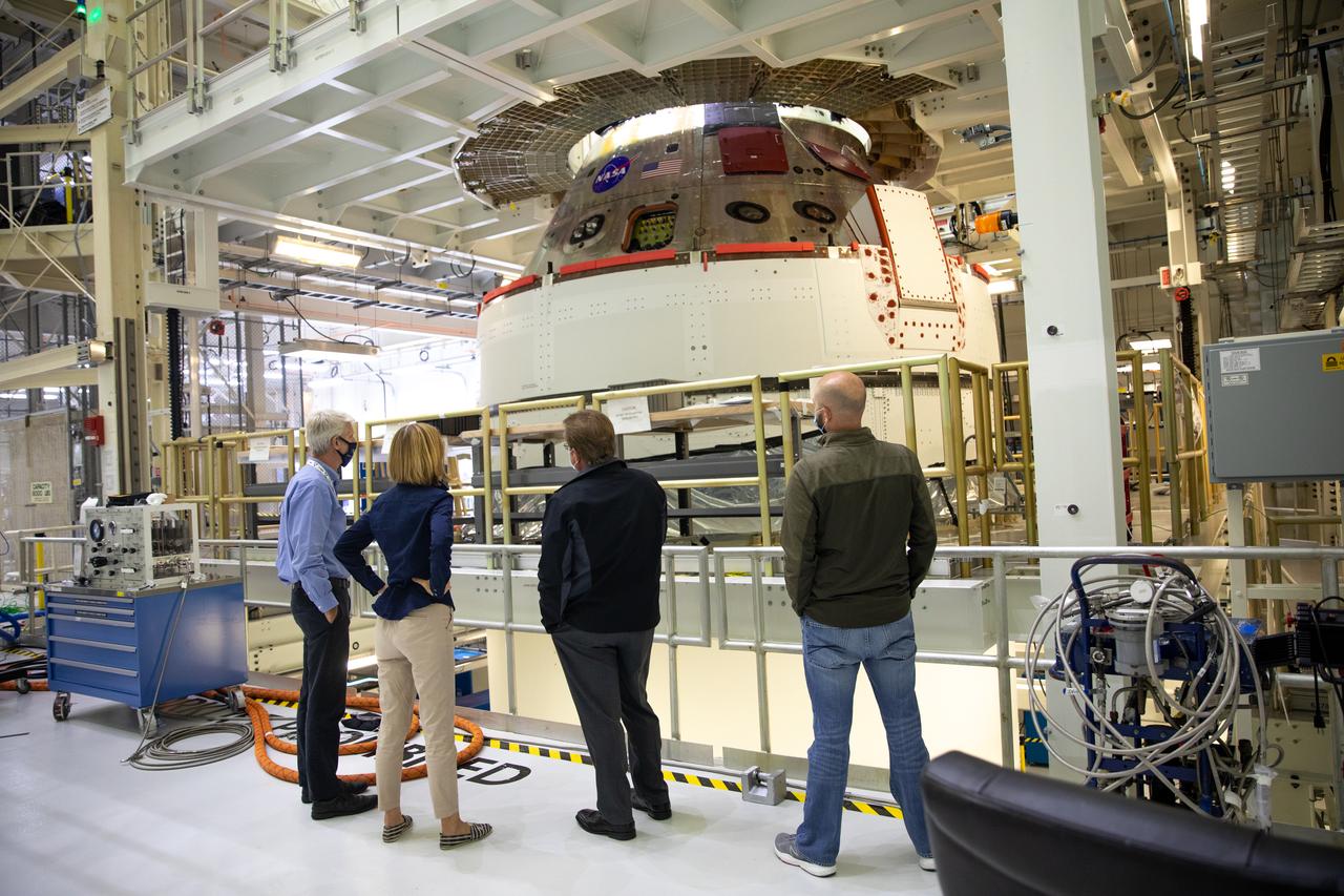 Senior managers from Orion, NASA, and Lockheed Martin view the Artemis I spacecraft during a visit to the Neil Armstrong Operations and Checkout Building high bay at NASA’s Kennedy Space Center in Florida on Nov. 5, 2020. From left are Scott Wilson, manager, Orion Production Office; Kathy Lueders, associate administrator of NASA’s Human Exploration and Operations Mission Directorate; Jules Schneider, director of Assembly, Test, and Launch Operations for Lockheed Martin; and Jim Skaggs, senior manager of Kennedy Operations for Lockheed Martin. The first in a series of increasingly complex missions, Artemis I will test the Space Launch System rocket and Orion spacecraft as an integrated system prior to crewed flights to the Moon. Under the Artemis program, NASA is planning to land the first woman and the next man on the lunar surface by 2024.