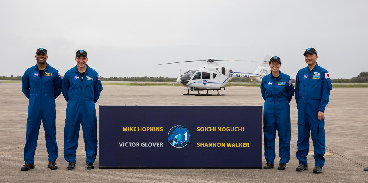 A crew arrival media event for NASA’s SpaceX Crew-1 mission is held Nov. 8, 2020, at the Launch and Landing Facility at the agency’s Kennedy Space Center in Florida. Posing for a photograph after speaking to the media, from left are, NASA astronaut Victor Glover, pilot; NASA astronaut Michael Hopkins, spacecraft commander; NASA astronaut Shannon Walker, mission specialist; and JAXA astronaut Soichi Noguchi, mission specialist. Crew-1 is the first crew rotation mission of a U.S. commercial spacecraft with astronauts to the International Space Station as part of NASA’s Commercial Crew Program. The SpaceX Crew Dragon spacecraft, named Resilience, will launch atop a Falcon 9 rocket from Kennedy’s Launch Complex 39A.