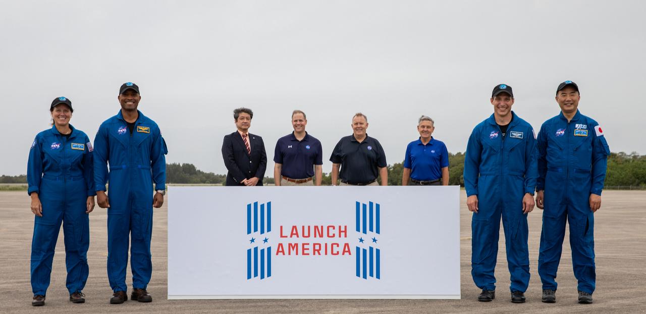 A crew arrival media event for NASA’s SpaceX Crew-1 mission is held Nov. 8, 2020, at the Launch and Landing Facility at the agency’s Kennedy Space Center in Florida. From left NASA astronaut Shannon Walker, mission specialist; NASA astronaut Victor Glover, pilot; Junichi Sakai, manager, International Space Station Program, JAXA; NASA Administrator Jim Bridenstine; NASA Deputy Administrator Jim Morhard; Bob Cabana, director, Kennedy Space Center; NASA astronaut Michael Hopkins, spacecraft commander; and JAXA astronaut Soichi Noguchi, mission specialist, pose for a photograph after speaking to members of the media. Crew-1 is the first crew rotation mission of a U.S. commercial spacecraft with astronauts to the International Space Station as part of NASA’s Commercial Crew Program. The SpaceX Crew Dragon spacecraft, named Resilience, will launch atop a Falcon 9 rocket from Kennedy’s Launch Complex 39A.