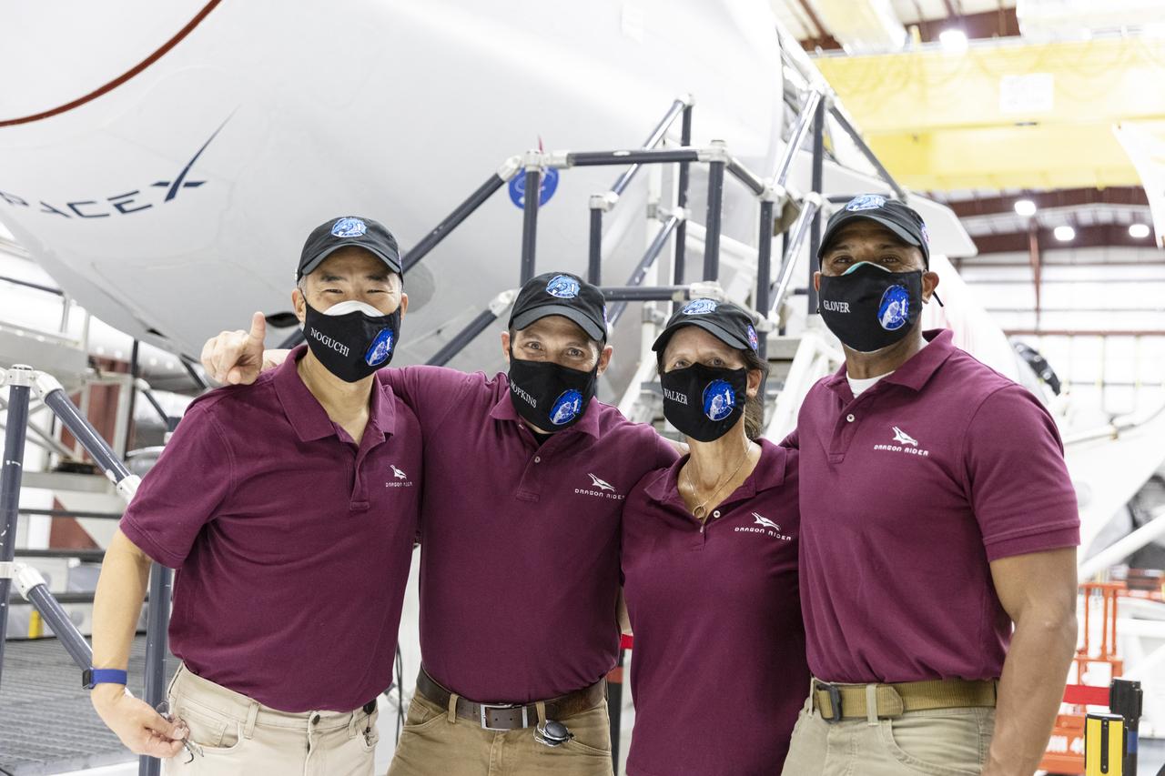The astronauts for NASA’s SpaceX Crew-1 mission pose for a photo in front of the Crew Dragon spacecraft, named Resilience by the crew, inside the SpaceX hangar at Launch Complex 39A on Nov. 8, 2020. From left, JAXA astronaut Soichi Noguchi, mission specialist; NASA astronaut Michael Hopkins, spacecraft commander; NASA astronaut Shannon Walker, mission specialist; and NASA astronaut Victor Glover, pilot. Crew-1 is the first crew rotation mission of a U.S. commercial spacecraft with astronauts to the International Space Station as part of NASA’s Commercial Crew Program.
