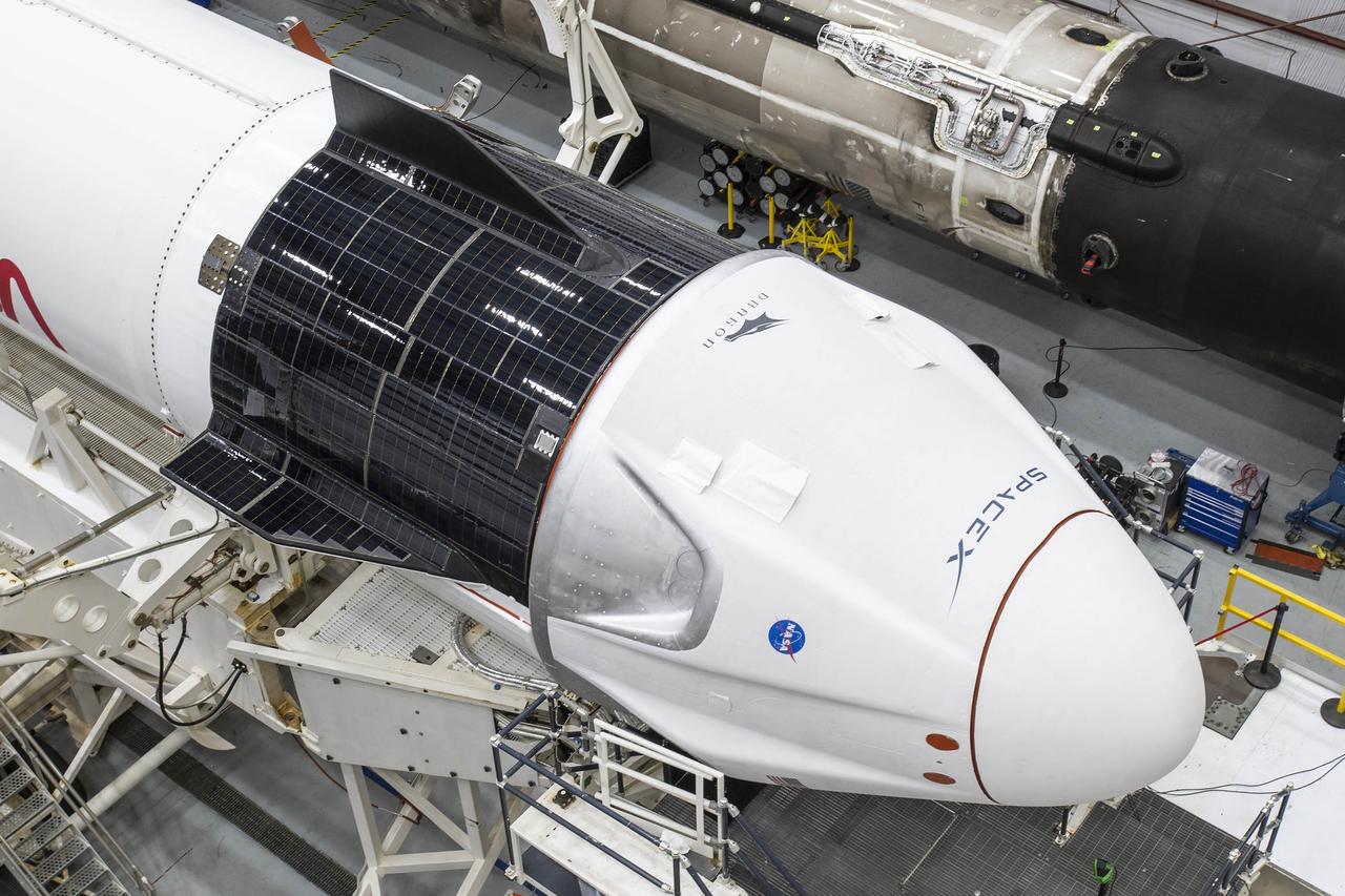 A SpaceX Falcon 9 rocket and Crew Dragon Resilience for NASA SpaceX’s Crew-1 mission are seen inside the SpaceX Hangar at NASA’s Kennedy Space Center in Florida on Nov. 9, 2020, before rollout to Launch Pad 39A. Crew-1 is the first regular crew mission of a U.S. commercial spacecraft with astronauts to the International Space Station as part of NASA’s Commercial Crew Program. The Crew Dragon capsule will launch atop a Falcon 9 rocket from Launch Complex 39A carrying NASA astronauts Michael Hopkins, Victor Glover, Shannon Walker and Japan Aerospace Exploration Agency (JAXA) astronaut Soichi Noguchi to the space station for a six-month science mission.