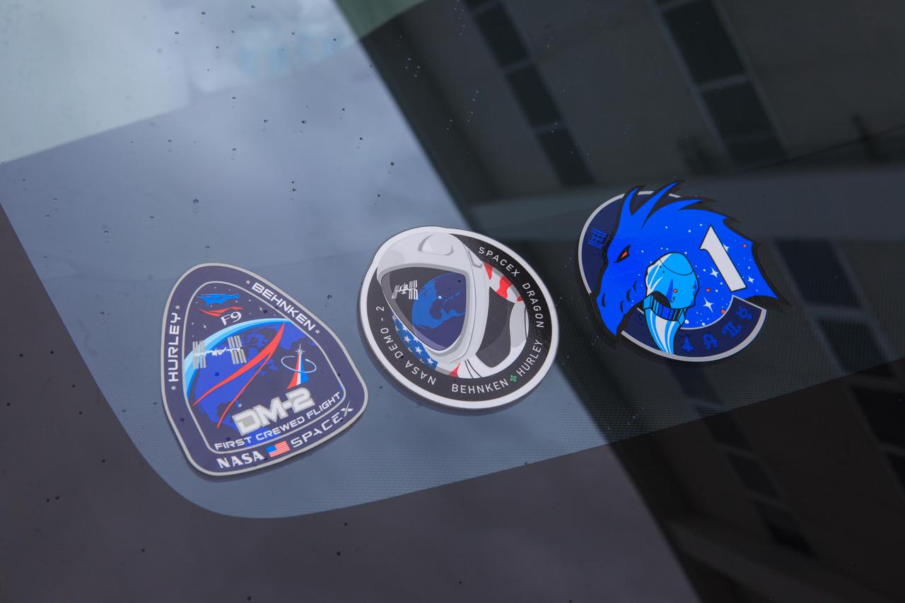 During a countdown dress rehearsal of launch day activities on Nov. 12, 2020, the mission and crew insignias for NASA’s SpaceX Crew-1 mission are in view in the windshield of a Tesla vehicle at the Neil Armstrong Operations and Checkout Building at Kennedy Space Center in Florida. Crew-1 is the first regular crew mission of a U.S. commercial spacecraft with astronauts to the International Space Station as part of NASA’s Commercial Crew Program. The SpaceX Crew Dragon Resilience capsule will launch atop the company’s Falcon 9 rocket from Launch Complex 39A carrying NASA astronauts Michael Hopkins, Victor Glover, Shannon Walker and Japan Aerospace Exploration Agency (JAXA) astronaut Soichi Noguchi to the space station for a six-month science mission.