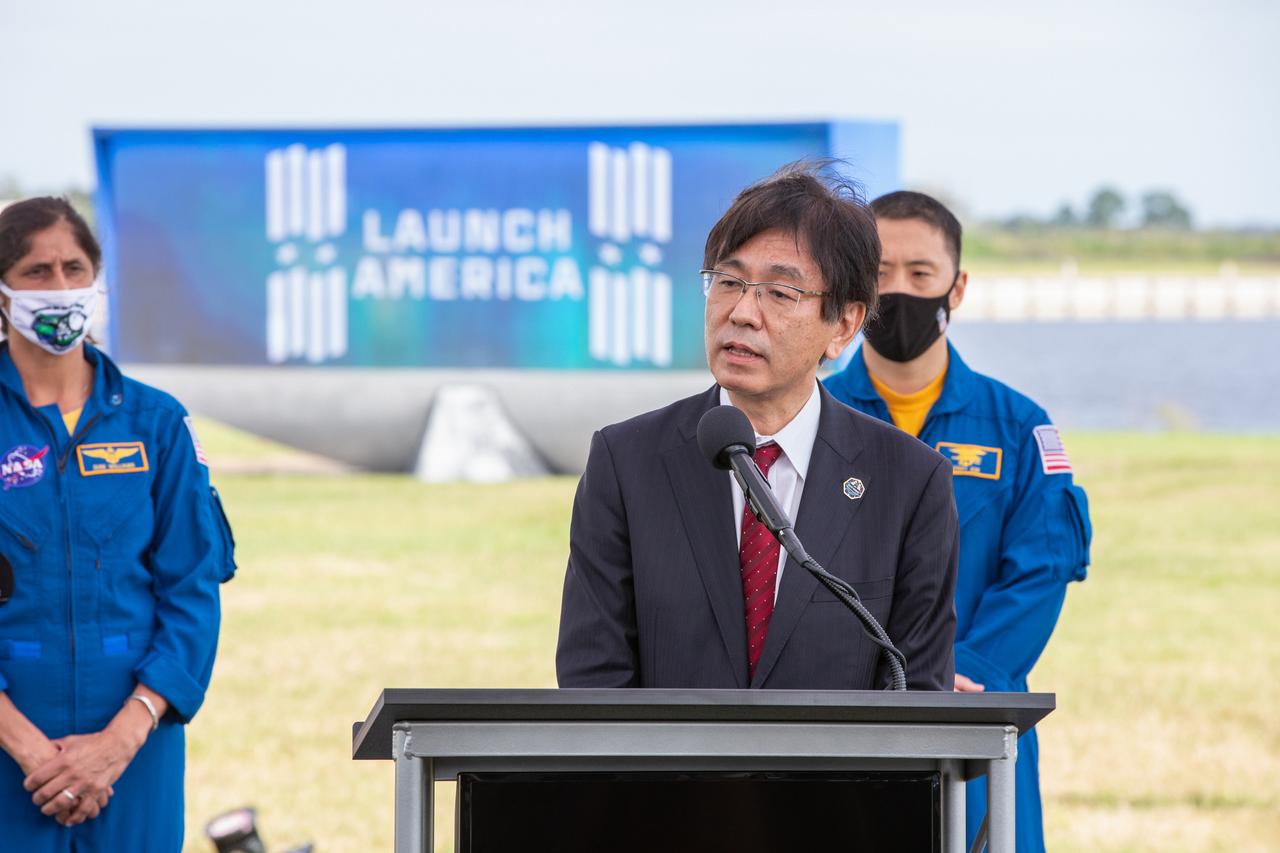 Hiroshi Sasaki, vice president and director general, JAXA’s Human Spaceflight, speaks during a press briefing Nov. 13, 2020, near the Press Site countdown clock at the agency’s Kennedy Space Center in Florida ahead of NASA’s SpaceX Crew-1 launch. Behind him, from left are NASA astronaut Sunita Williams, and NASA astronaut Jonny Kim. Crew-1 is the first regular crew mission of a U.S. commercial spacecraft with astronauts to the International Space Station as part of NASA’s Commercial Crew Program. The SpaceX Crew Dragon Resilience capsule will launch atop the company’s Falcon 9 rocket from Launch Complex 39A to the space station for a six-month science mission.