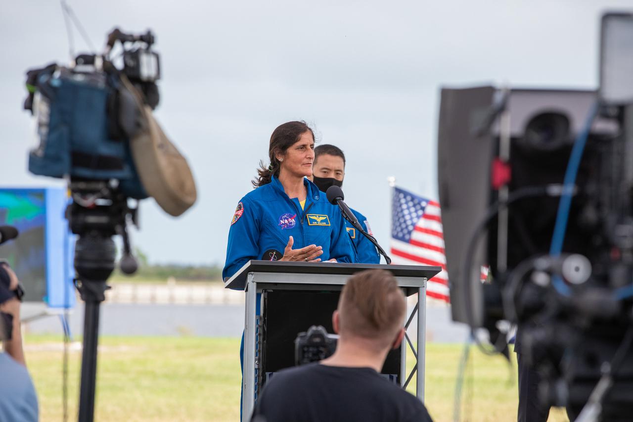 NASA astronaut Sunita Williams, speaks during a press briefing Nov. 13, 2020, near the Press Site countdown clock at the agency’s Kennedy Space Center in Florida ahead of NASA’s SpaceX Crew-1 launch. Behind him is a mock-up of the SpaceX Crew Dragon capsule. Crew-1 is the first regular crew mission of a U.S. commercial spacecraft with astronauts to the International Space Station as part of NASA’s Commercial Crew Program. The SpaceX Crew Dragon Resilience capsule will launch atop the company’s Falcon 9 rocket from Launch Complex 39A to the space station for a six-month science mission.