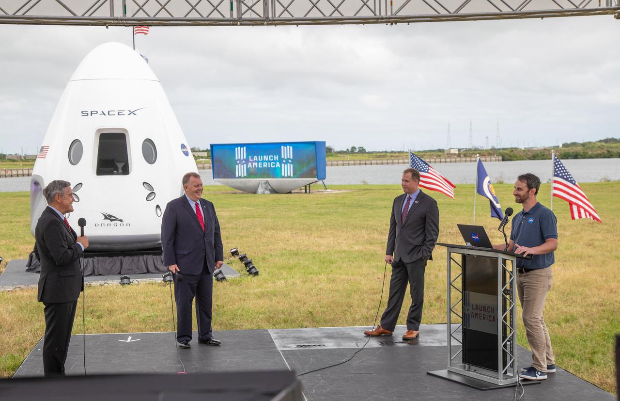 Joshua Santora, far right, NASA Communications, moderates a press briefing Nov. 13, 2020, near the Press Site countdown clock at the agency’s Kennedy Space Center in Florida ahead of NASA’s SpaceX Crew-1 launch. Speaking to the media, from right, are Kennedy Space Center Director Bob Cabana, NASA Deputy Administrator Jim Morhard, and NASA Administrator Jim Bridenstine. Crew-1 is the first regular crew mission of a U.S. commercial spacecraft with astronauts to the International Space Station as part of NASA’s Commercial Crew Program. The SpaceX Crew Dragon Resilience capsule will launch atop the company’s Falcon 9 rocket from Launch Complex 39A to the space station for a six-month science mission.