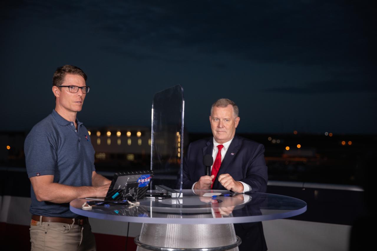 During live television coverage of NASA SpaceX’s Crew-1 launch on Nov. 15, 2020, Derrol Nail, left, NASA Communications, talks with NASA Deputy Administrator Jim Morhard on the observation deck of Operations Support Building II at Kennedy Space Center in Florida.  Crew-1 is the first regular crew mission of a U.S. commercial spacecraft with astronauts to the International Space Station as part of NASA’s Commercial Crew Program. The Crew Dragon Resilience capsule will launch atop a Falcon 9 rocket from Launch Complex 39A carrying NASA astronauts Michael Hopkins, Victor Glover, Shannon Walker and Japan Aerospace Exploration Agency (JAXA) astronaut Soichi Noguchi to the space station for a six-month science mission.