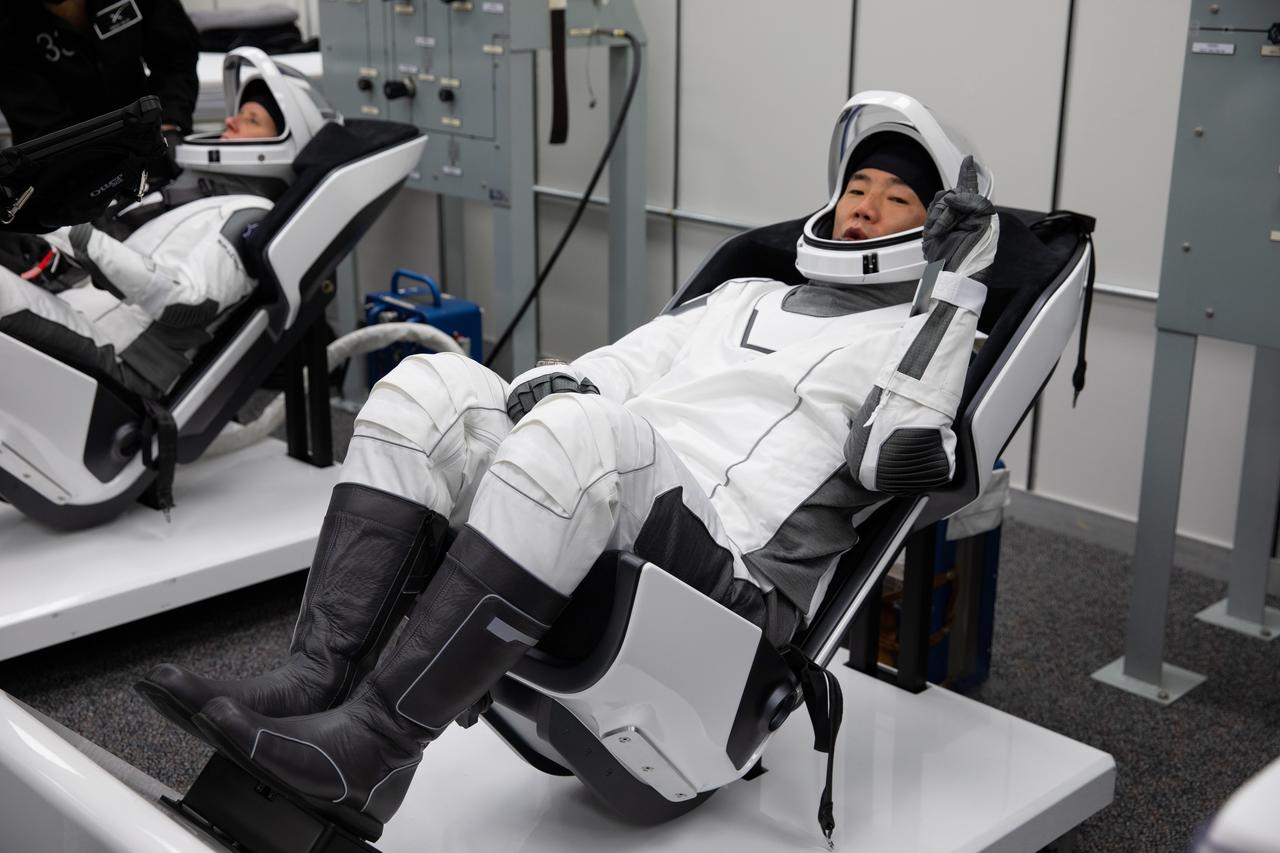 Inside the crew suit-up room in the Neil Armstrong Operations and Checkout Building at NASA’s Kennedy Space Center in Florida, on Nov. 15, 2020, Japan Aerospace Exploration Agency (JAXA) astronaut Soichi Noguchi, at right, mission specialist, is shown in a SpaceX spacesuit in preparation for NASA SpaceX’s Crew-1 mission. At left is NASA astronaut Shannon Walker, mission specialist, also in a SpaceX spacesuit. Crew-1 is the first regular crew mission of a U.S. commercial spacecraft with astronauts to the International Space Station as part of NASA’s Commercial Crew Program. The SpaceX Crew Dragon Resilience capsule will launch atop the company’s Falcon 9 rocket from Launch Complex 39A to the space station for a six-month science mission.