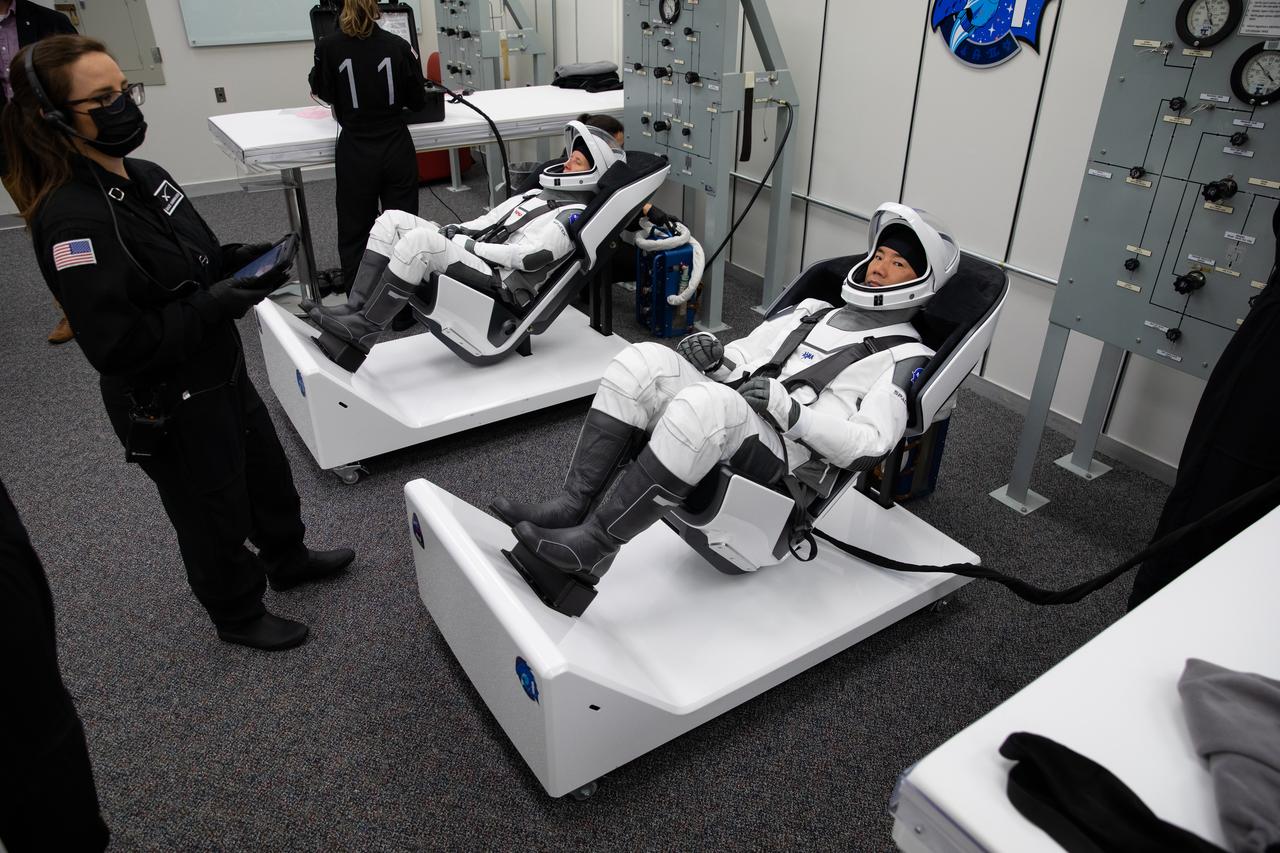 Inside the crew suit-up room in the Neil Armstrong Operations and Checkout Building at NASA’s Kennedy Space Center in Florida, on Nov. 15, 2020, Japan Aerospace Exploration Agency (JAXA) astronaut Soichi Noguchi, at right, mission specialist, is shown in a SpaceX spacesuit in preparation for NASA SpaceX’s Crew-1 mission. At left is NASA astronaut Shannon Walker, mission specialist, also in a SpaceX spacesuit. Crew-1 is the first regular crew mission of a U.S. commercial spacecraft with astronauts to the International Space Station as part of NASA’s Commercial Crew Program. The SpaceX Crew Dragon Resilience capsule will launch atop the company’s Falcon 9 rocket from Launch Complex 39A to the space station for a six-month science mission.