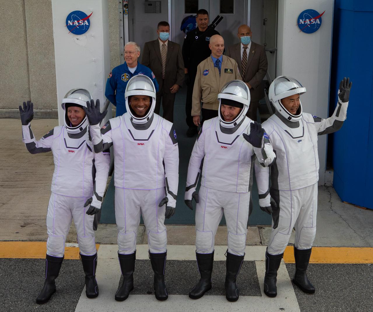 The NASA SpaceX Crew-1 astronauts emerge from the Neil Armstrong Operations and Checkout Building at NASA’s Kennedy Space Center in Florida on Nov. 15, 2020. From left are NASA astronaut Shannon Walker, mission specialist; NASA astronaut Victor Glover, pilot; NASA astronaut Michael Hopkins, spacecraft commander; and JAXA astronaut Soichi Noguchi, mission specialist. They will board two Tesla vehicles for the trip to Launch Complex 39A. Crew-1 is the first regular crew mission of a U.S. commercial spacecraft with astronauts to the International Space Station as part of NASA’s Commercial Crew Program. The SpaceX Crew Dragon Resilience capsule will launch atop the company’s Falcon 9 rocket from Pad 39A to the space station for a six-month science mission.