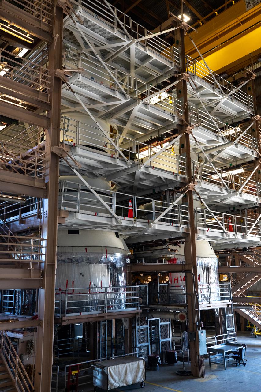 Inside the Rotation, Processing and Surge Facility at NASA’s Kennedy Space Center in Florida on Nov. 17, 2020, the left and right booster segments for the Space Launch System are being prepared for their move to the Vehicle Assembly Building (VAB). Workers with Exploration Ground Systems and contractor Jacobs teams will stack the twin five-segment boosters on the mobile launcher inside the VAB over a number of weeks. When the core stage arrives, it will join the boosters on the mobile launcher, followed by the interim cryogenic propulsion stage and Orion spacecraft. Manufactured by Northrop Grumman in Utah, the twin boosters provide more than 75 percent of the total SLS thrust at launch. Under the Artemis program, NASA will land the first woman and the next man on the Moon by 2024. The first in a series of increasingly complex missions, Artemis I will test the Orion spacecraft and SLS as an integrated system ahead of crewed flights to the Moon.