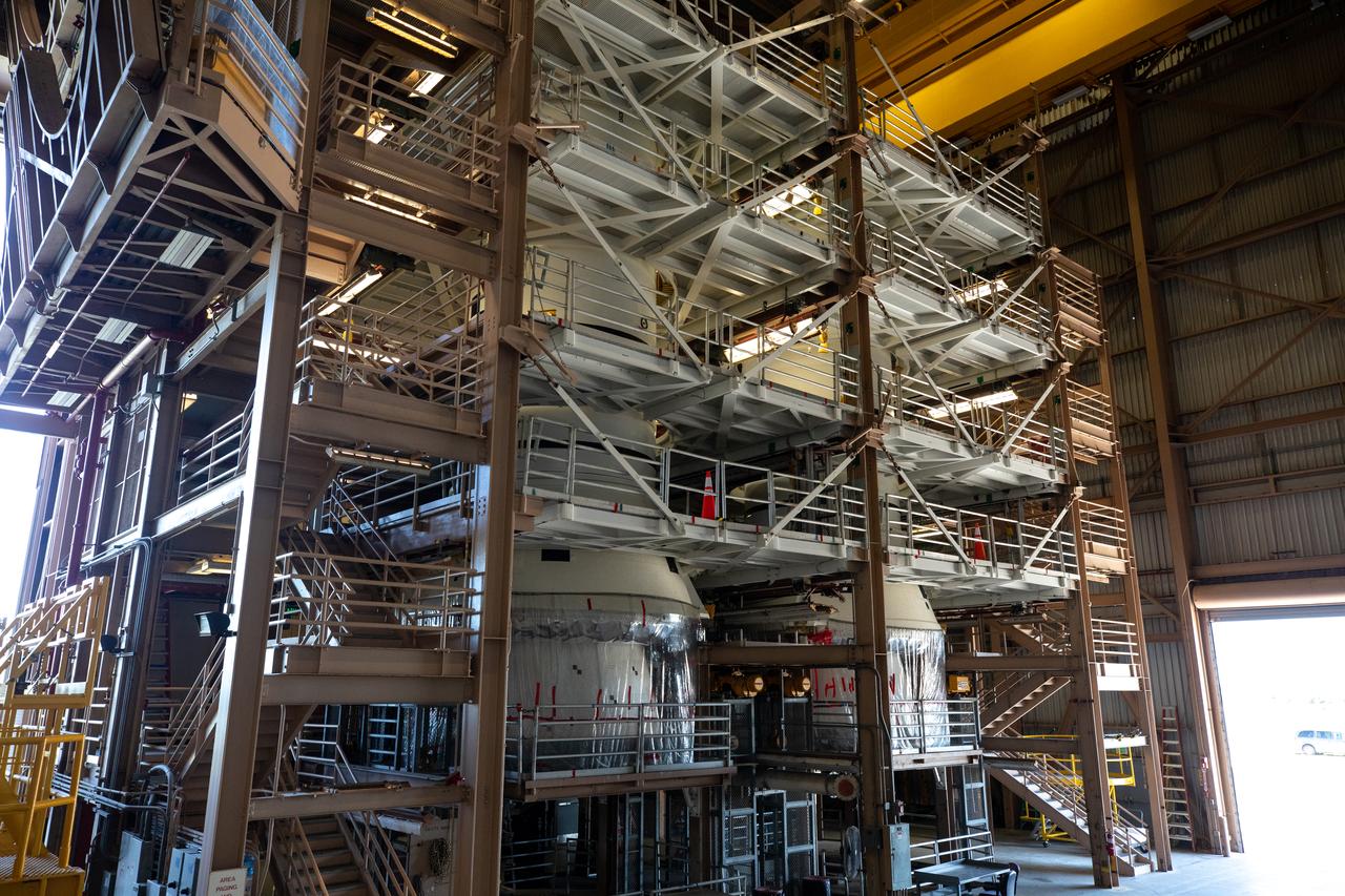 Inside the Rotation, Processing and Surge Facility at NASA’s Kennedy Space Center in Florida on Nov. 17, 2020, the left and right booster segments for the Space Launch System are being prepared for their move to the Vehicle Assembly Building (VAB). Workers with Exploration Ground Systems and contractor Jacobs teams will stack the twin five-segment boosters on the mobile launcher inside the VAB over a number of weeks. When the core stage arrives, it will join the boosters on the mobile launcher, followed by the interim cryogenic propulsion stage and Orion spacecraft. Manufactured by Northrop Grumman in Utah, the twin boosters provide more than 75 percent of the total SLS thrust at launch. Under the Artemis program, NASA will land the first woman and the next man on the Moon by 2024. The first in a series of increasingly complex missions, Artemis I will test the Orion spacecraft and SLS as an integrated system ahead of crewed flights to the Moon.