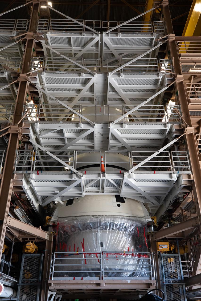 In view inside the Rotation, Processing and Surge Facility at NASA’s Kennedy Space Center in Florida on Nov. 17, 2020, one of the twin booster segments for the Space Launch System is being prepared for its move to the Vehicle Assembly Building (VAB). Workers with Exploration Ground Systems and contractor Jacobs teams will stack the twin five-segment boosters on the mobile launcher inside the VAB over a number of weeks. When the core stage arrives, it will join the boosters on the mobile launcher, followed by the interim cryogenic propulsion stage and Orion spacecraft. Manufactured by Northrop Grumman in Utah, the twin boosters provide more than 75 percent of the total SLS thrust at launch. Under the Artemis program, NASA will land the first woman and the next man on the Moon by 2024. The first in a series of increasingly complex missions, Artemis I will test the Orion spacecraft and SLS as an integrated system ahead of crewed flights to the Moon.