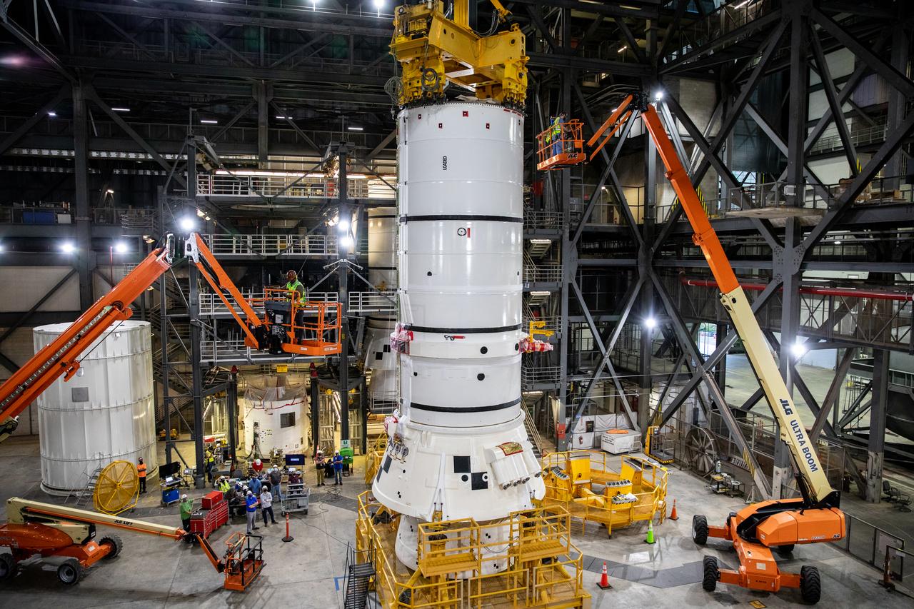 In High Bay 4 of the Vehicle Assembly Building (VAB) at NASA’s Kennedy Space Center in Florida, one of the Artemis I aft booster segments for the Space Launch System is being prepared for its lift up and lowering onto the mobile launcher in High Bay 3 for stacking operations on Nov. 20, 2020. Workers with Exploration Ground Systems and contractor Jacobs teams will stack the twin five-segment boosters on the mobile launcher in High Bay 3 over a number of weeks. When the core stage arrives, it will join the boosters on the mobile launcher, followed by the interim cryogenic propulsion stage and Orion spacecraft. Manufactured by Northrop Grumman in Utah, the twin boosters provide more than 75 percent of the total SLS thrust at launch. The SLS is managed by Marshall Space Flight Center in Huntsville, Alabama. Under the Artemis program, NASA will land the first woman and the next man on the Moon by 2024. The first in a series of increasingly complex missions, Artemis I will test the Orion spacecraft and SLS as an integrated system ahead of crewed flights to the Moon.
