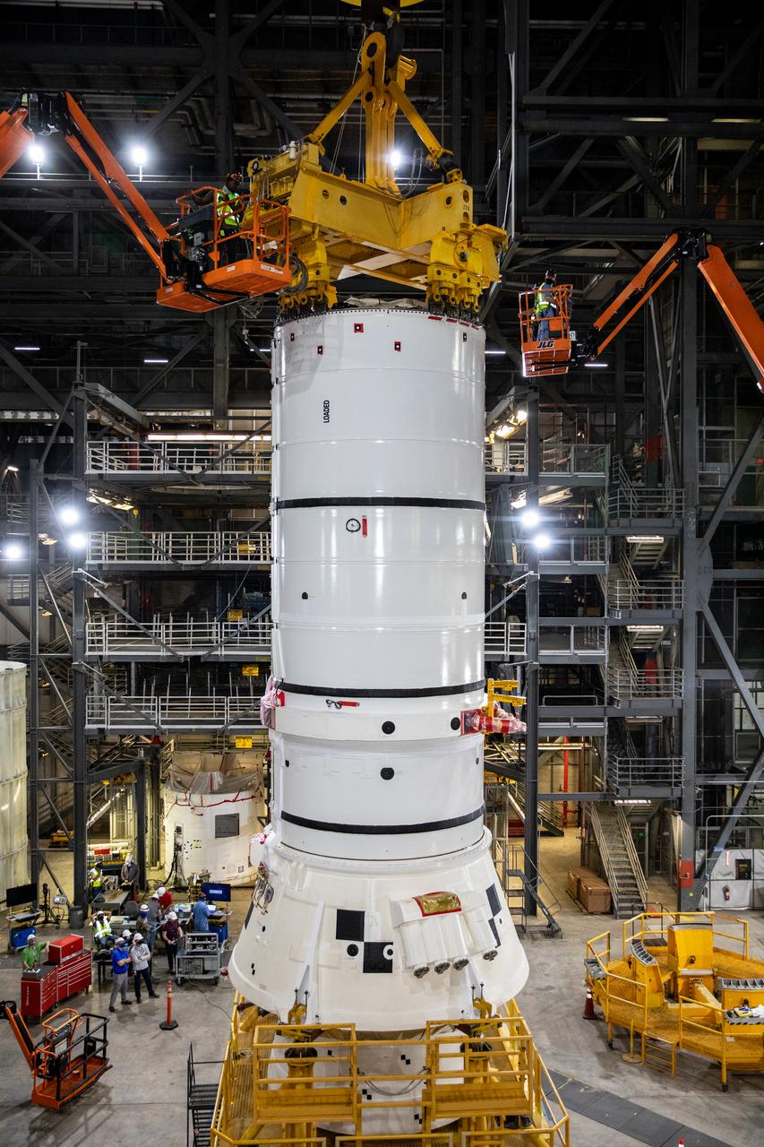 In High Bay 4 of the Vehicle Assembly Building (VAB) at NASA’s Kennedy Space Center in Florida, one of the Artemis I aft booster segments for the Space Launch System is being prepared for its lift up and lowering onto the mobile launcher in High Bay 3 for stacking operations on Nov. 20, 2020. Workers with Exploration Ground Systems and contractor Jacobs teams will stack the twin five-segment boosters on the mobile launcher in High Bay 3 over a number of weeks. When the core stage arrives, it will join the boosters on the mobile launcher, followed by the interim cryogenic propulsion stage and Orion spacecraft. Manufactured by Northrop Grumman in Utah, the twin boosters provide more than 75 percent of the total SLS thrust at launch. The SLS is managed by Marshall Space Flight Center in Huntsville, Alabama. Under the Artemis program, NASA will land the first woman and the next man on the Moon by 2024. The first in a series of increasingly complex missions, Artemis I will test the Orion spacecraft and SLS as an integrated system ahead of crewed flights to the Moon.