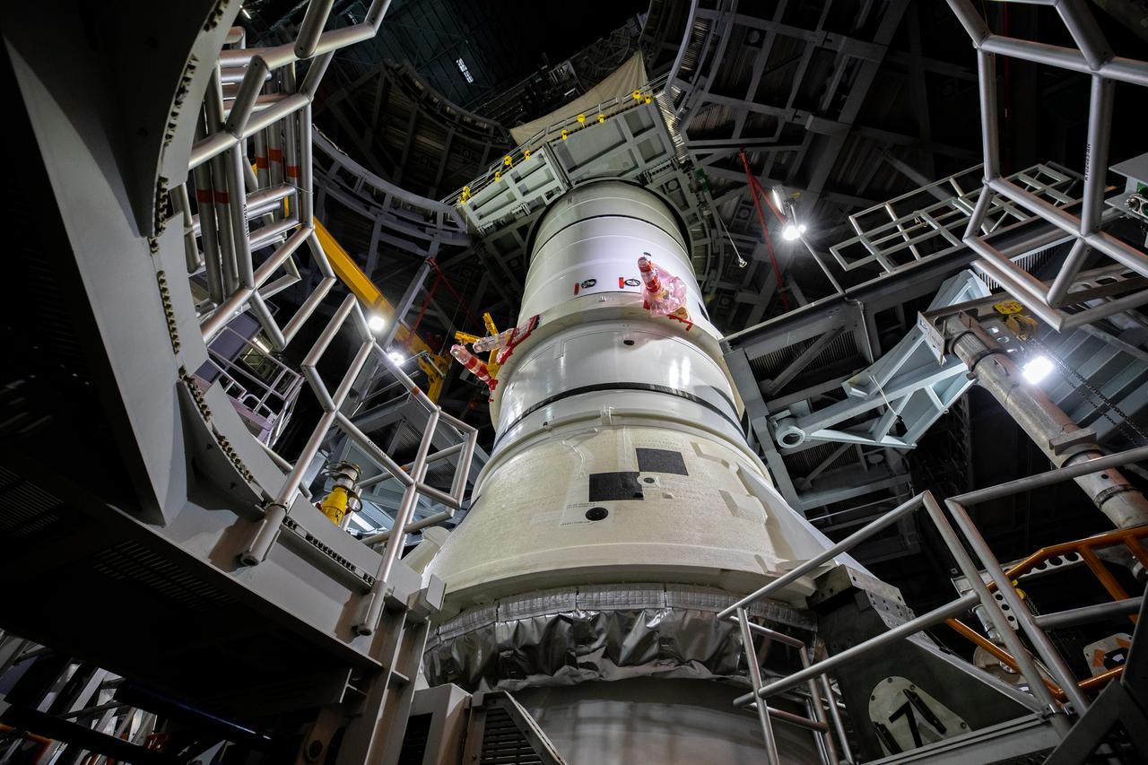 The first of two Artemis I aft booster segments for the Space Launch System is lowered onto the mobile launcher in High Bay 3 of the Vehicle Assembly Building (VAB) at NASA’s Kennedy Space Center in Florida on Nov. 23, 2020. Workers with Exploration Ground Systems and contractor Jacobs teams will stack the twin five-segment boosters on the mobile launcher in High Bay 3 over a number of weeks. When the core stage arrives, it will join the boosters on the mobile launcher, followed by the interim cryogenic propulsion stage and Orion spacecraft. Manufactured by Northrop Grumman in Utah, the twin boosters provide more than 75 percent of the total SLS thrust at launch. The SLS is managed by Marshall Space Flight Center in Huntsville, Alabama. Under the Artemis program, NASA will land the first woman and the next man on the Moon by 2024. The first in a series of increasingly complex missions, Artemis I will test the Orion spacecraft and SLS as an integrated system ahead of crewed flights to the Moon.