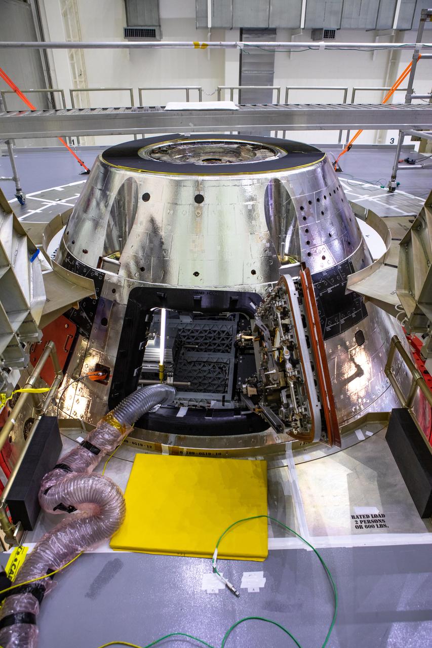 The forward bay cover is installed on the Artemis I spacecraft in the Final Assembly and System Testing (FAST) cell inside the Neil Armstrong Operations and Checkout building high bay at NASA’s Kennedy Space Center in Florida on Nov. 23, 2020. It protects the upper part of Orion during the mission and, upon reentry into Earth’s atmosphere, jettison mechanisms will push the forward bay cover a safe distance from the spacecraft, allowing the three main parachutes to unfurl and slow Orion to a safe speed for splashdown in the Pacific Ocean. The first in a series of increasingly complex mission, Artemis I will test the Space Launch System rocket and Orion spacecraft as an integrated system prior to crewed flights to the Moon. Under the Artemis program, NASA is planning to land the first woman and next man on the lunar surface by 2024.