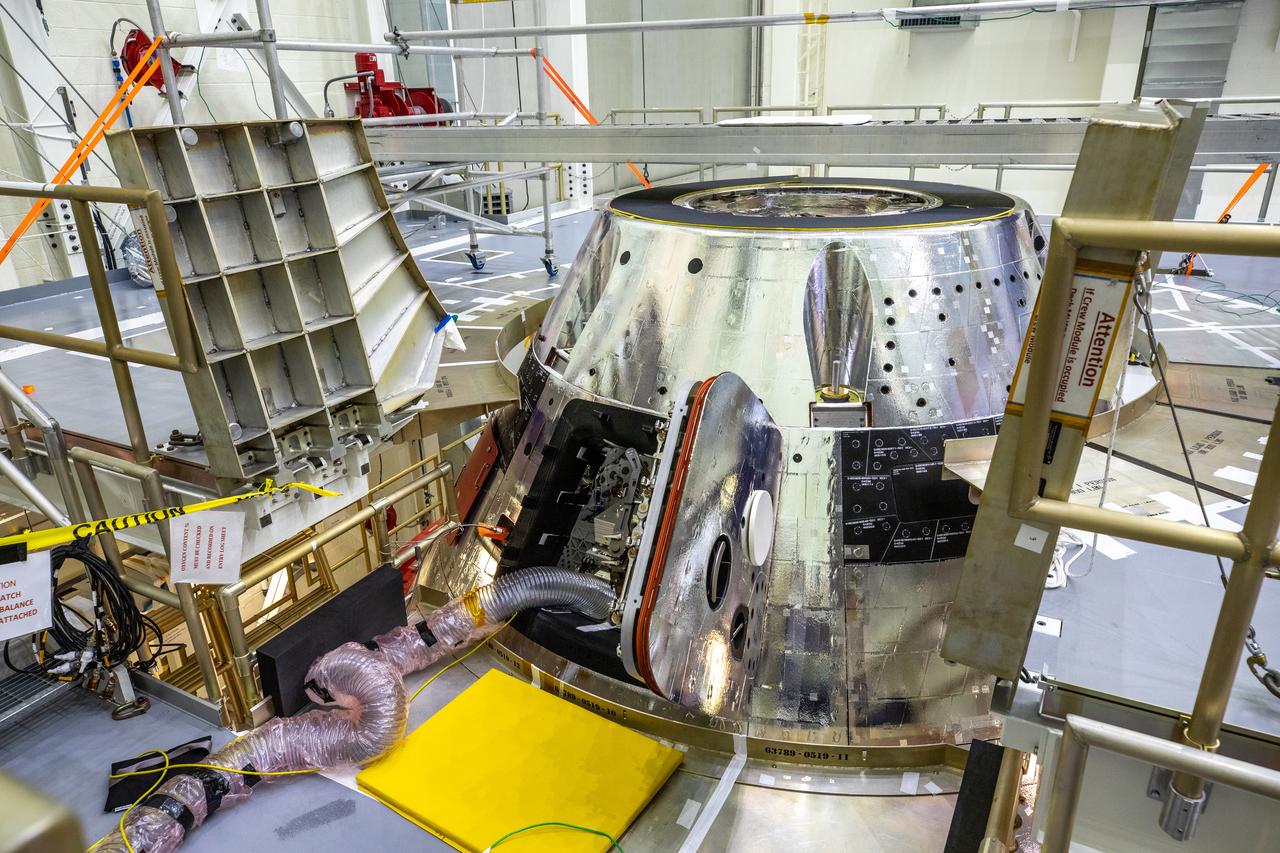 The forward bay cover is installed on the Artemis I spacecraft in the Final Assembly and System Testing (FAST) cell inside the Neil Armstrong Operations and Checkout building high bay at NASA’s Kennedy Space Center in Florida on Nov. 23, 2020. It protects the upper part of Orion during the mission and, upon reentry into Earth’s atmosphere, jettison mechanisms will push the forward bay cover a safe distance from the spacecraft, allowing the three main parachutes to unfurl and slow Orion to a safe speed for splashdown in the Pacific Ocean. The first in a series of increasingly complex mission, Artemis I will test the Space Launch System rocket and Orion spacecraft as an integrated system prior to crewed flights to the Moon. Under the Artemis program, NASA is planning to land the first woman and next man on the lunar surface by 2024.
