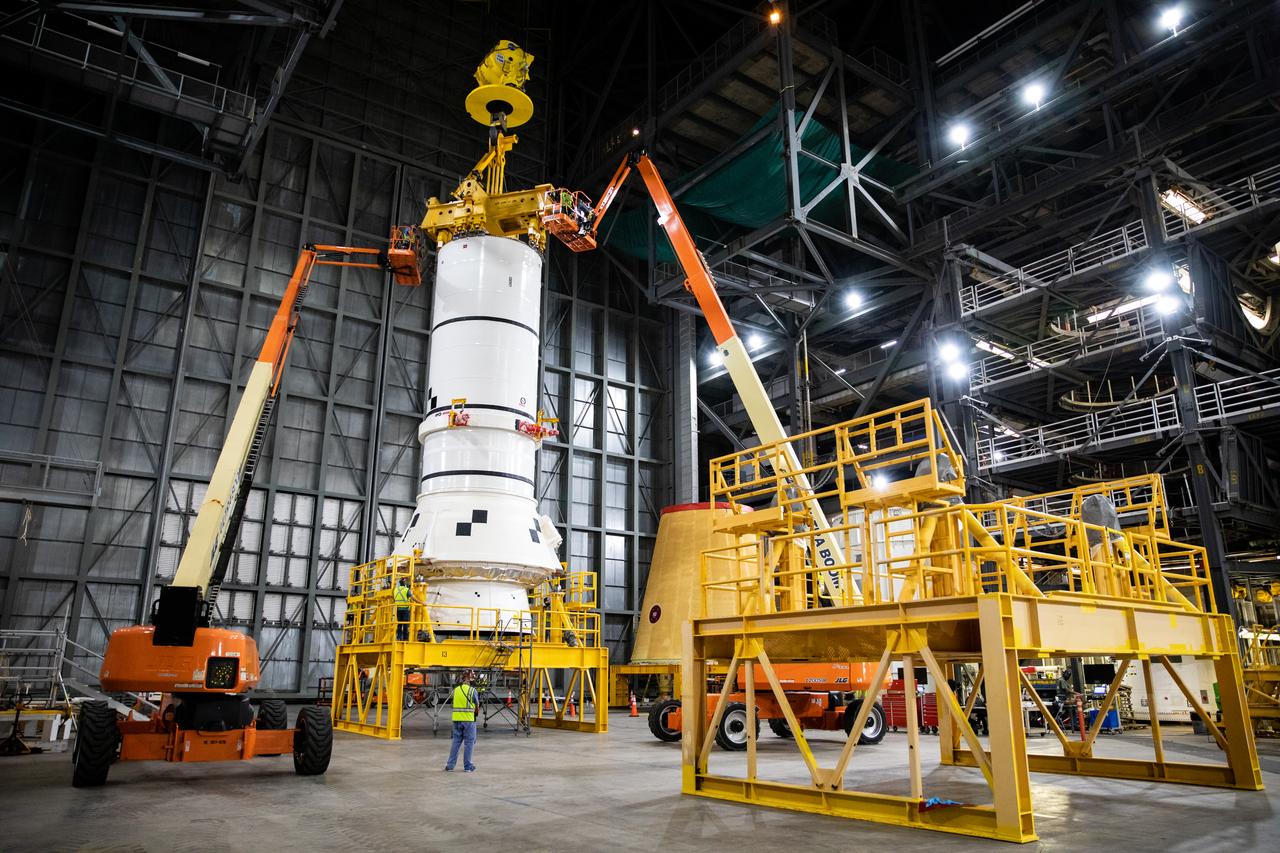 In the transfer aisle of the Vehicle Assembly Building (VAB) at NASA’s Kennedy Space Center in Florida, the second of two Artemis I aft booster segments for the Space Launch System is being prepared for its move into High Bay 3 on Nov. 24, 2020. Workers with Exploration Ground Systems and contractor Jacobs teams will stack the twin five-segment boosters on the mobile launcher in High Bay 3 over a number of weeks. When the core stage arrives, it will join the boosters on the mobile launcher, followed by the interim cryogenic propulsion stage and Orion spacecraft. Manufactured by Northrop Grumman in Utah, the twin boosters provide more than 75 percent of the total SLS thrust at launch. The SLS is managed by Marshall Space Flight Center in Huntsville, Alabama. Under the Artemis program, NASA will land the first woman and the next man on the Moon by 2024. The first in a series of increasingly complex missions, Artemis I will test the Orion spacecraft and SLS as an integrated system ahead of crewed flights to the Moon.