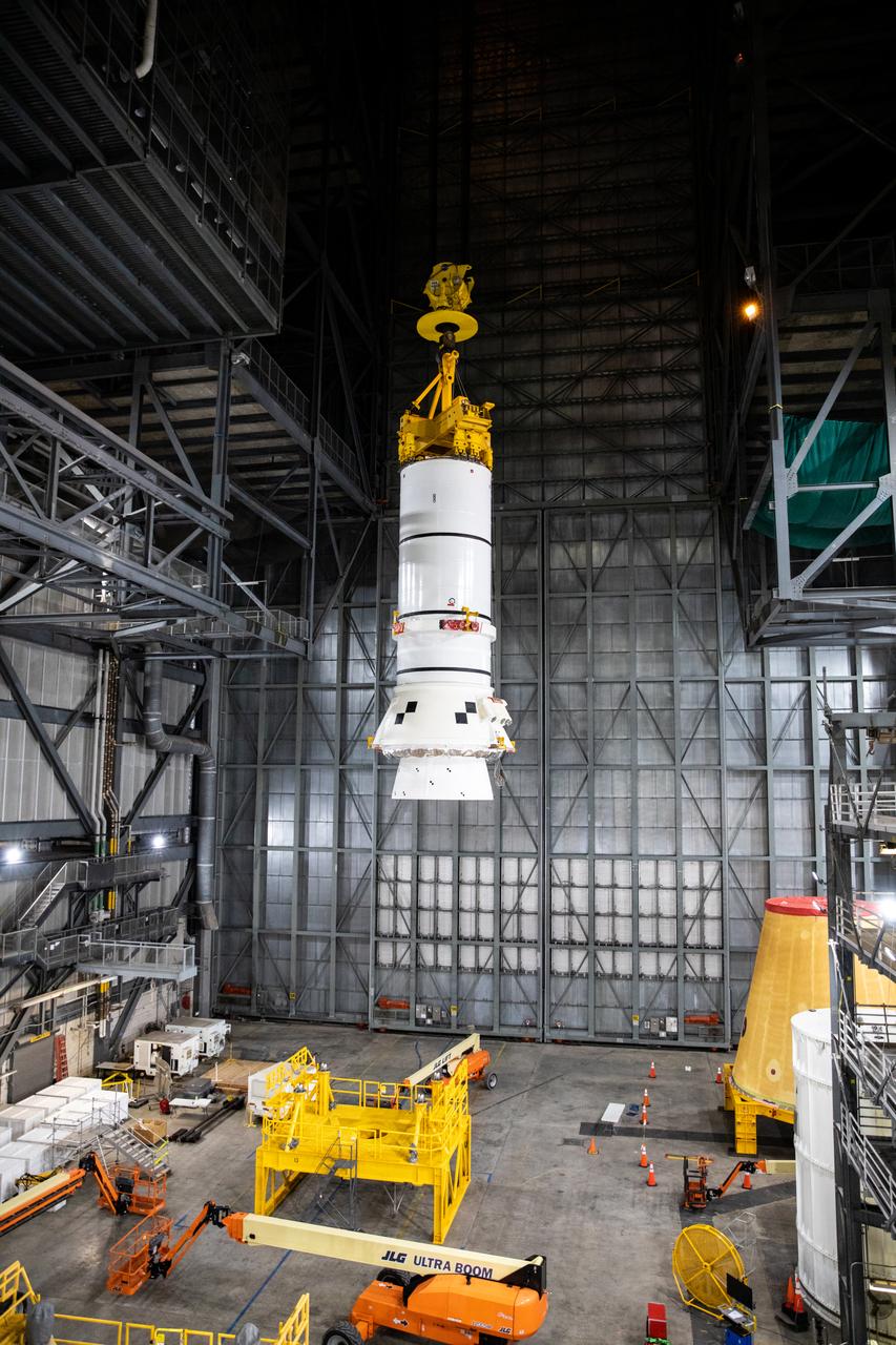 In the transfer aisle of the Vehicle Assembly Building (VAB) at NASA’s Kennedy Space Center in Florida, the second of two Artemis I aft booster segments for the Space Launch System is lifted by crane for its move into High Bay 3 on Nov. 24, 2020. Workers with Exploration Ground Systems and contractor Jacobs teams will stack the twin five-segment boosters on the mobile launcher in High Bay 3 over a number of weeks. When the core stage arrives, it will join the boosters on the mobile launcher, followed by the interim cryogenic propulsion stage and Orion spacecraft. Manufactured by Northrop Grumman in Utah, the twin boosters provide more than 75 percent of the total SLS thrust at launch. The SLS is managed by Marshall Space Flight Center in Huntsville, Alabama. Under the Artemis program, NASA will land the first woman and the next man on the Moon by 2024. The first in a series of increasingly complex missions, Artemis I will test the Orion spacecraft and SLS as an integrated system ahead of crewed flights to the Moon.